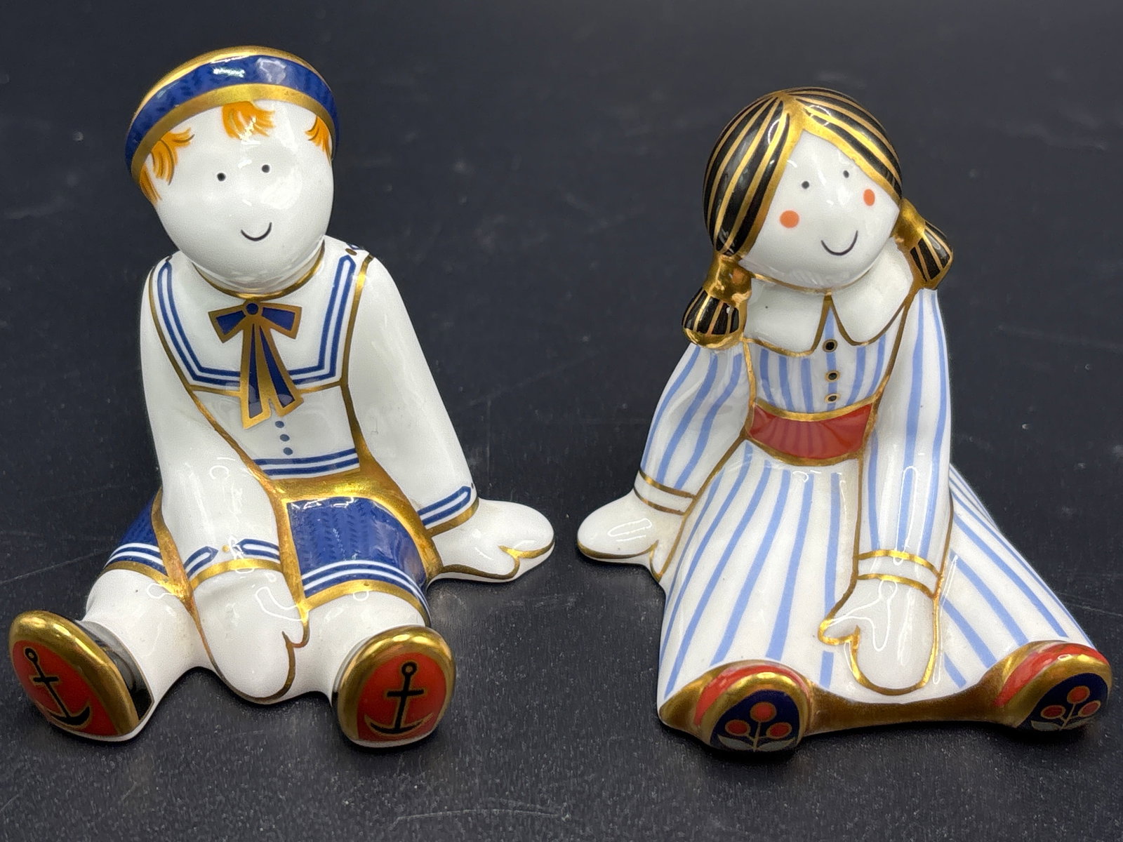 Royal Crown Derby ‘Ragdoll & Ragdoll Sailor’3 inch paperweight statues: Ragdoll is Artist signed. Royal Crown Derby porcelain figures from the "Treasures of Childhood" collection.The set includes the "Ragdoll Sailor" and "Ragdoll" figures.These miniature figurines were in