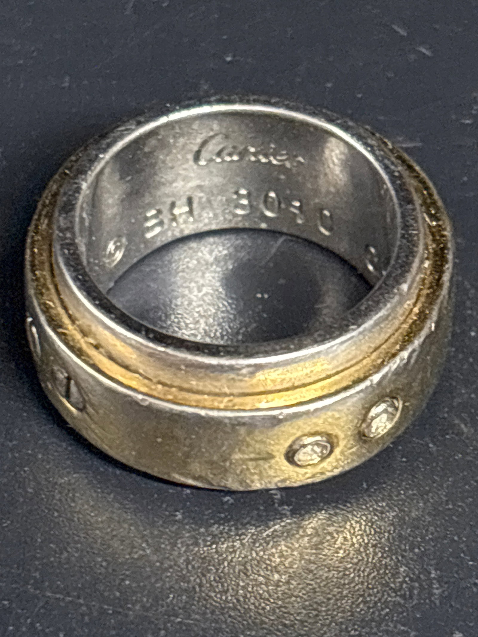 Authentic 18 k gold & stainless steel vintage Cartier Santos 100 ring; size 9: Approximate size 9.vintage Cartier Santos 100 ring, featuring a signature two-tone aesthetic crafted from 18K yellow gold and stainless steel (indicated by the internal "Acier / Or 750" hallmarks). [1