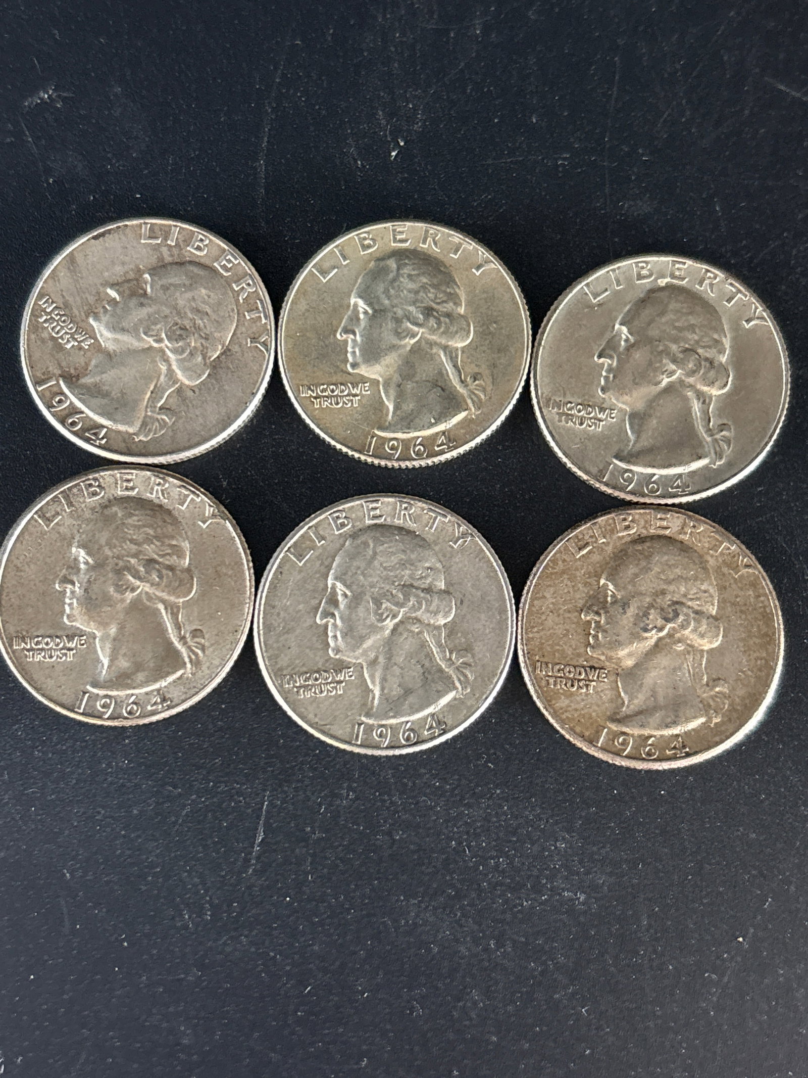 Six silver 1964 Washington quarter United States coins: Six 1964 Washington quarters, which is notable as the last year these coins were struck for circulation with 90% silver.As of July 2026, circulated coins from this year are generally valued between $1