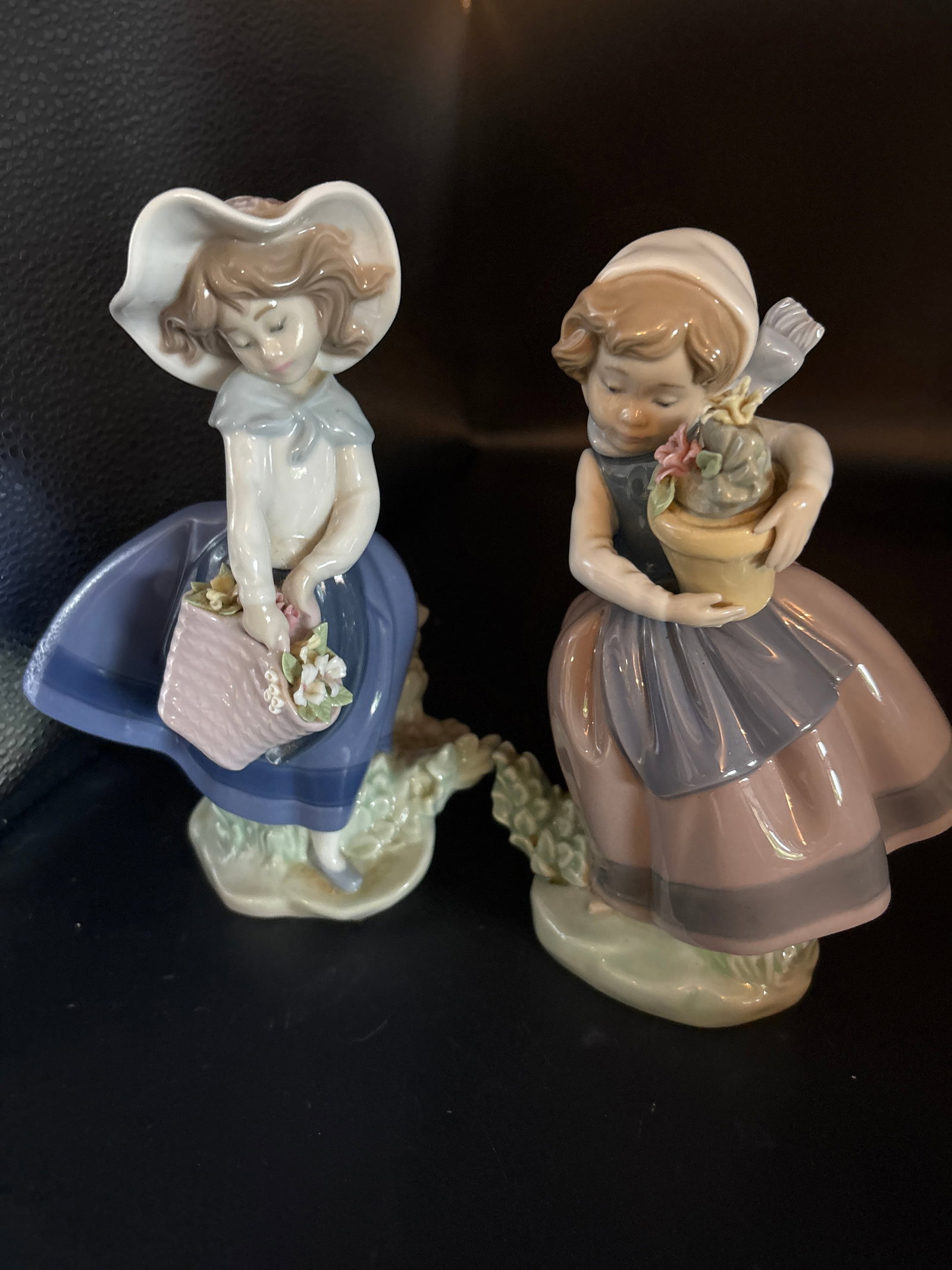 Two original Lladro Spainish porcelain girls with flowers 7 inch statues: Good condition but no box.Two original Lladro Spainish porcelain girls with flowers 7 inch statuesLladró porcelain figurine titled Pretty Pickings (SKU: 01005222), depicting a young girl with a baske