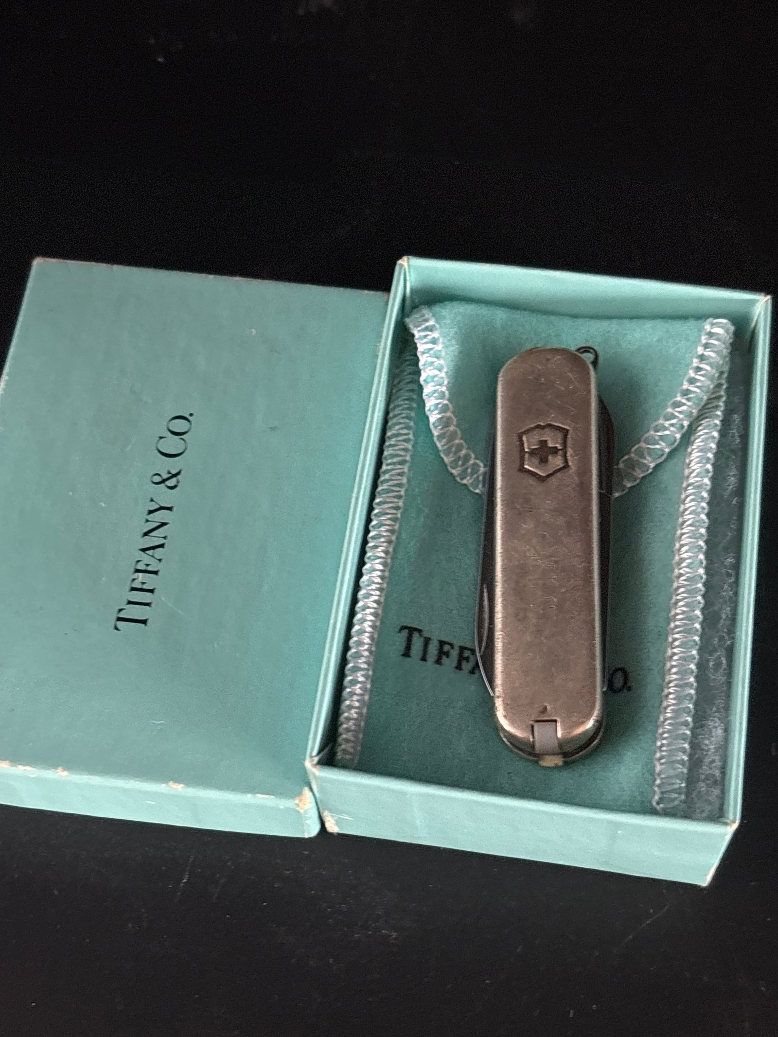 Vintage Tiffany & Co. Victorinox Swiss Army knife .925 & .750 gold casing: Tiffany & Co. x Victorinox Swiss Army Knife featuring a sterling silver casing.It typically includes tools such as a small blade, scissors, nail file, tweezers, and a toothpick.These are often markete