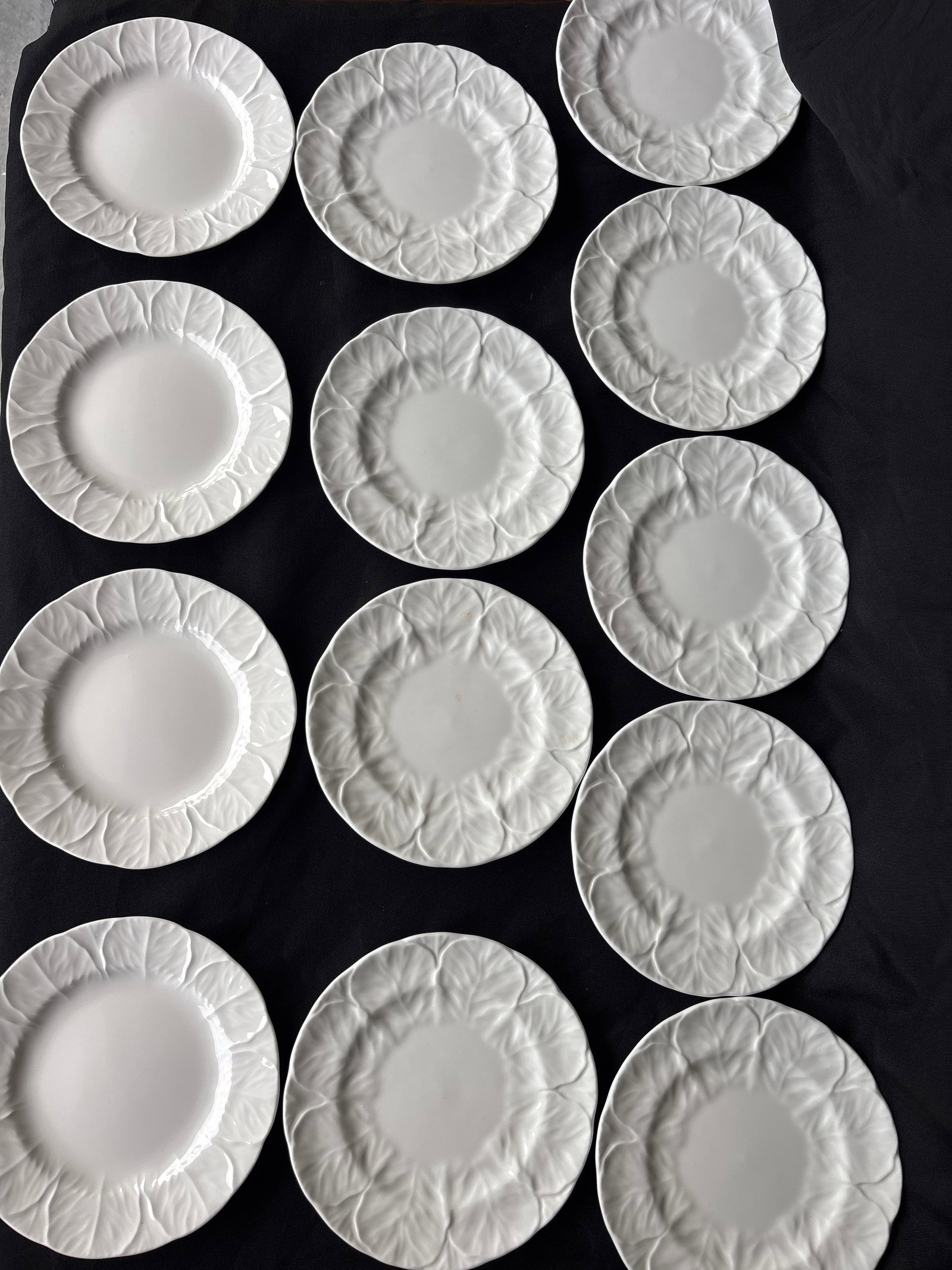 Thirteen Wedgwood Countryware English white bone china plates: Thirteen Wedgwood Countryware white bone china plates featuring an embossed cabbage leaf pattern.The pattern was originally produced by Coalport before being manufactured under the Wedgwood mark.Items