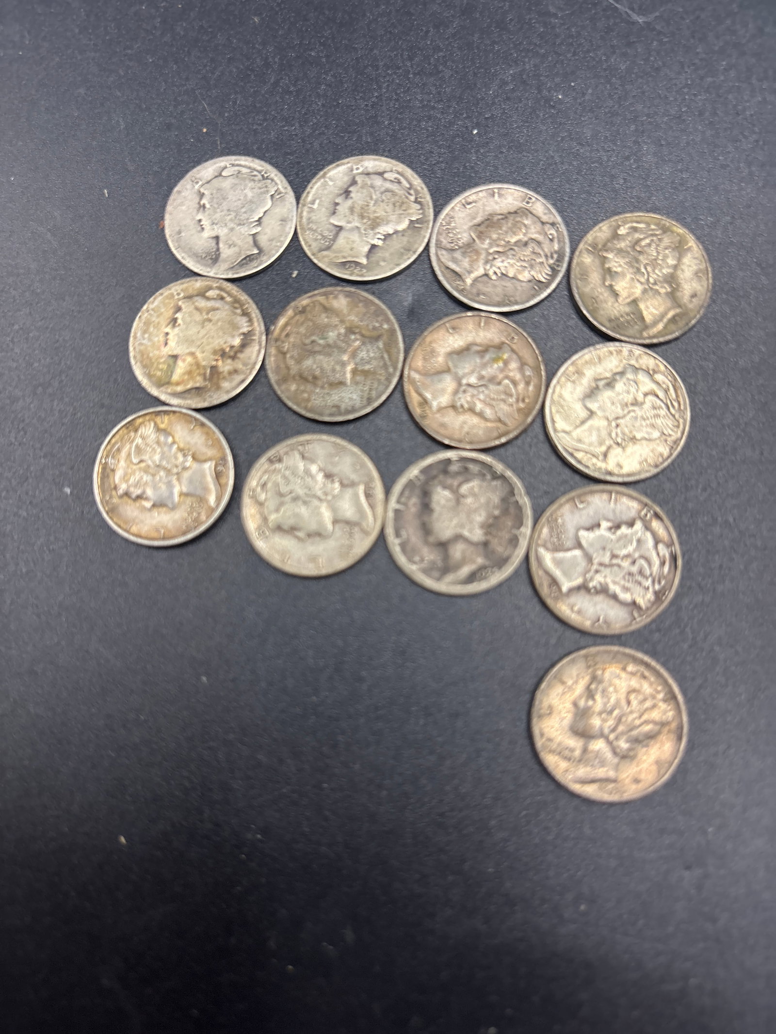 Thirteen silver early Mercury head United States dimes: Thirteen early Mercury dime, officially known as the Winged Liberty Head dime.It was designed by Adolph A. Weinman and features Liberty wearing a winged cap rather than the Roman god Mercury.The coins