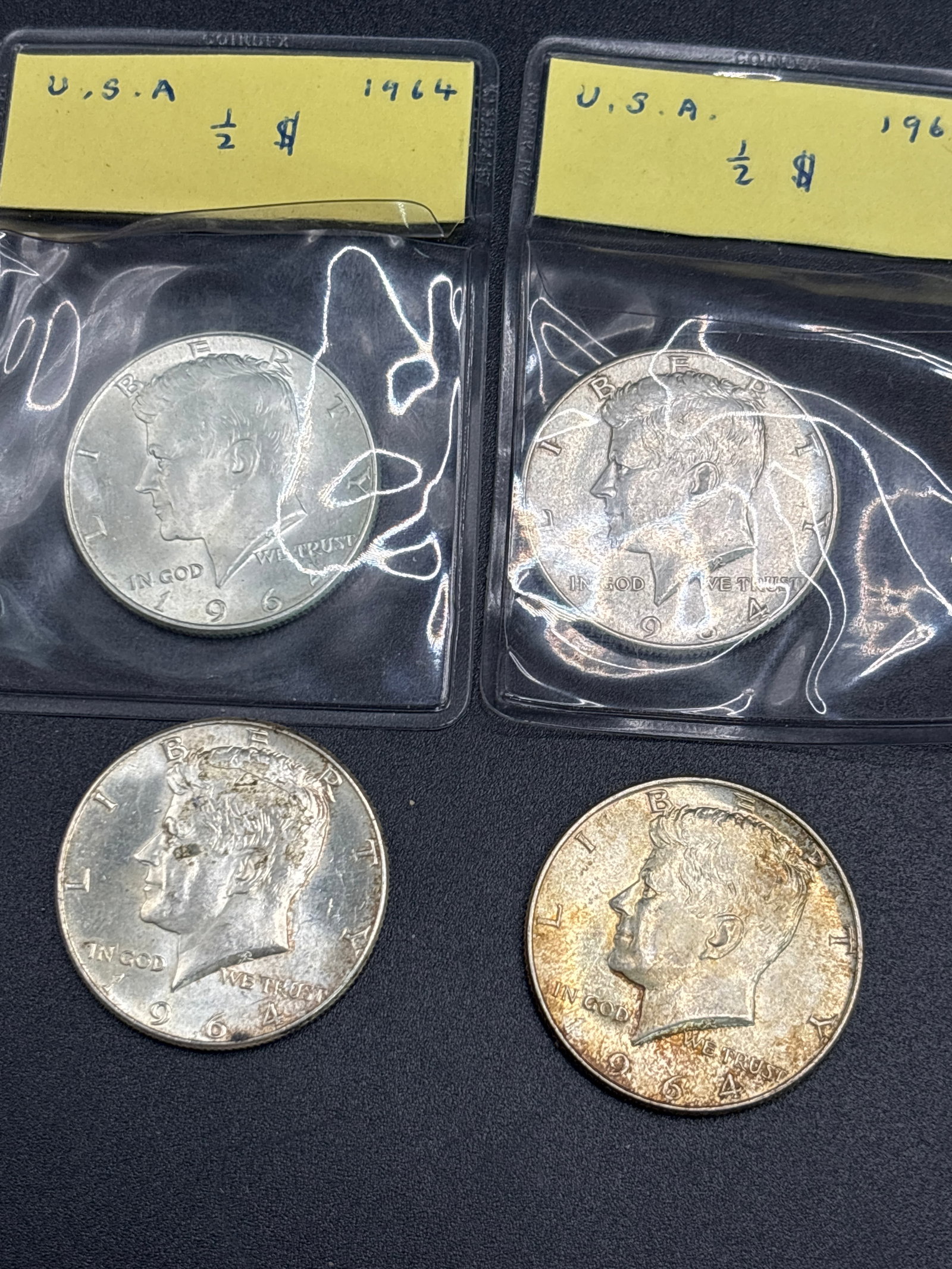 Four silver U.S. Kennedy half dollar coin, which was first issued in 1964 (1 of 6)