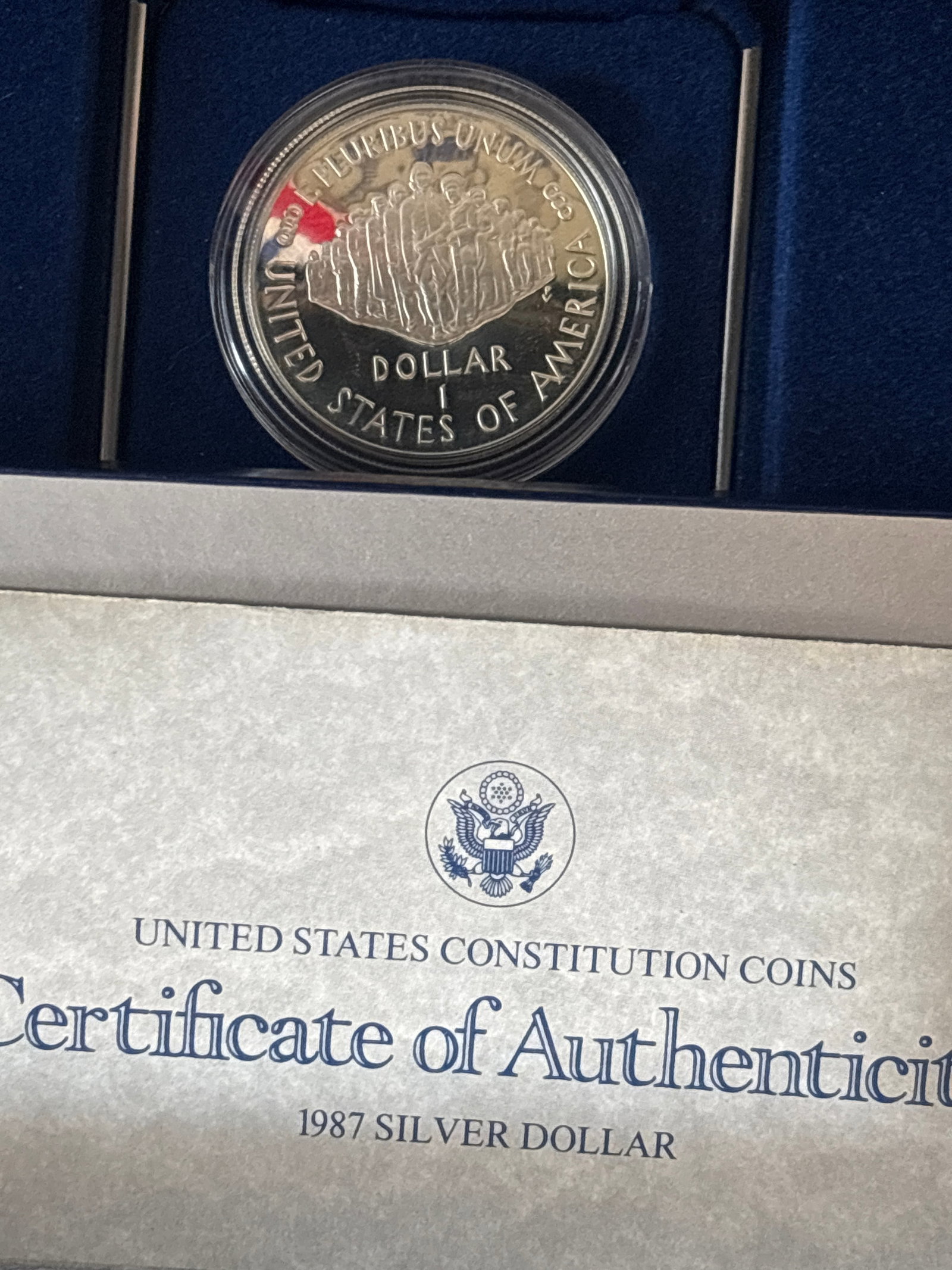27 grams 90% silver 1987 United States Constitution Bicentennial Commemorative dollar: 1987 United States Constitution Bicentennial Commemorative Silver Dollar, struck to honor the 200th anniversary of the adoption of the U.S. Constitution. This specific coin features a proof finish and