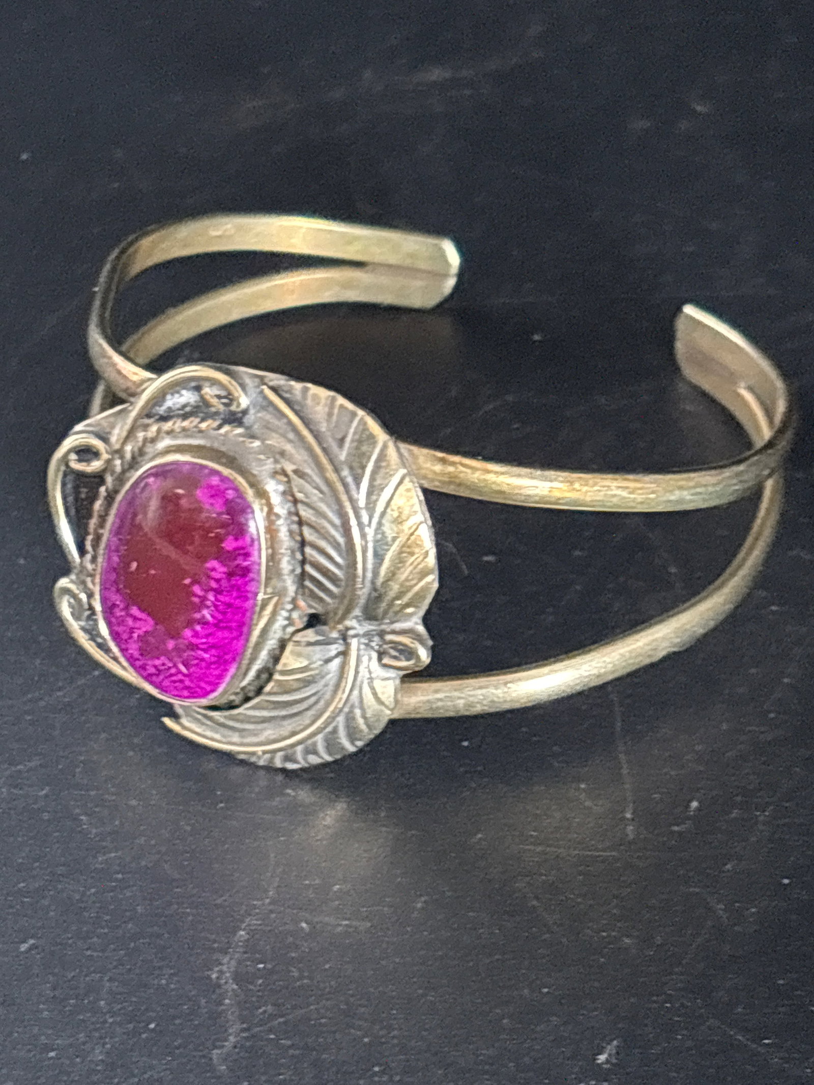 20 grams Sterling Mexican stone inlay cuff bracelet: Native Indian -style sterling silver cuff bracelet featuring a burgundy or pink stone.The bracelet likely features a cabochon-cut gemstone, which is polished rather than faceted.Similar styles often