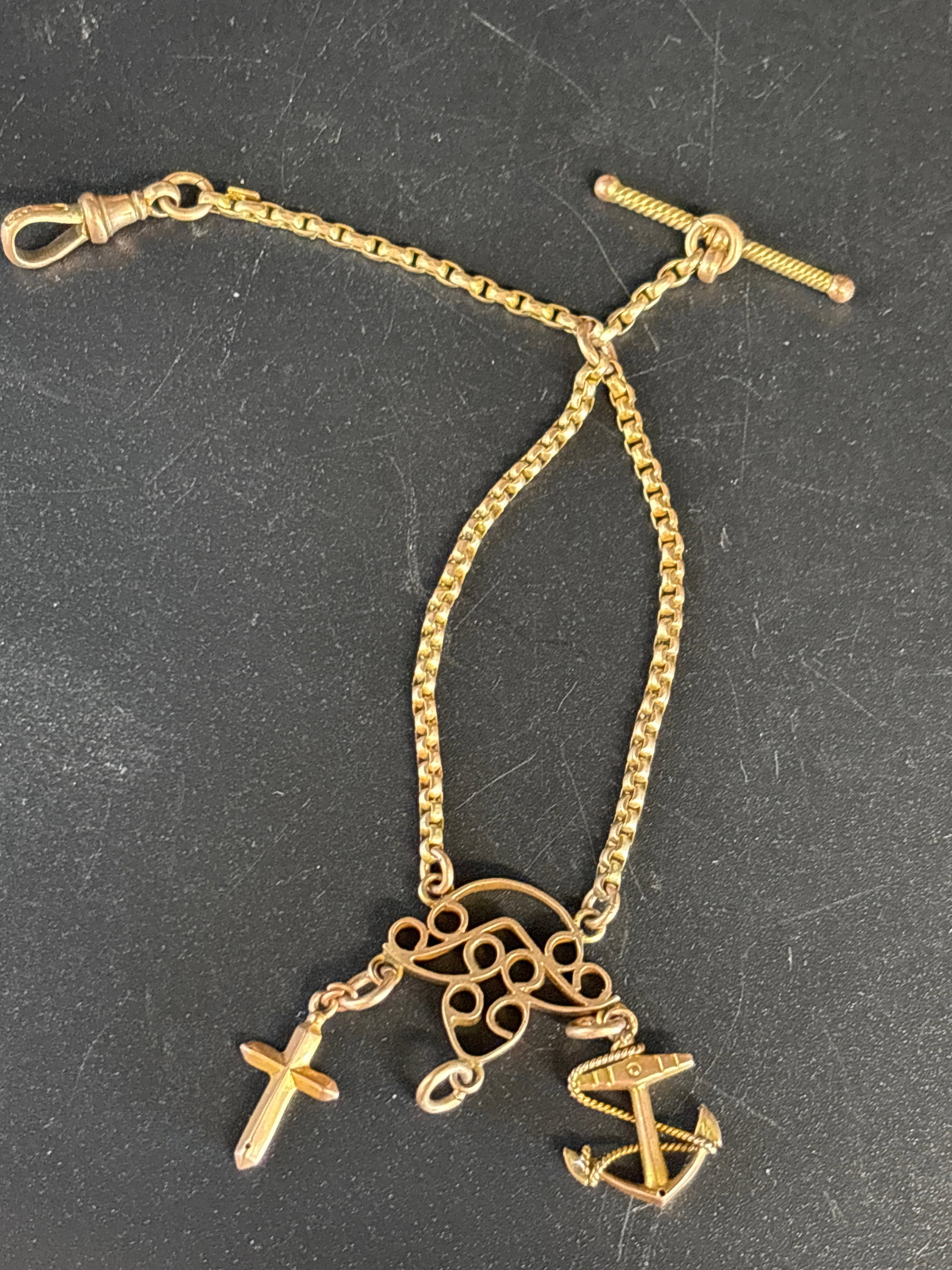 English 9 k gold antique Victorian Albertina bracelet: English 9 k gold antique Victorian Albertina bracelet features a T-bar and delicate charm pendants.Style: Antique Victorian Albertina bracelet, originally designed as a feminine watch chain.Material: 