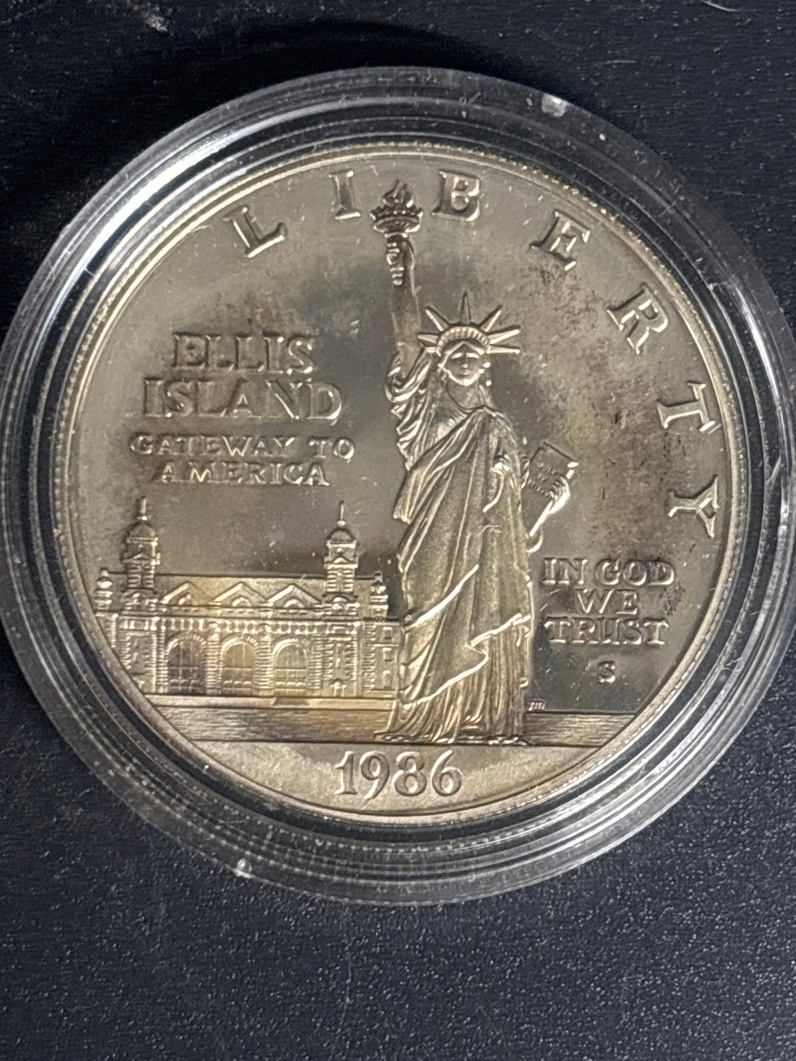 Encapsulated 1986-S Statue of Liberty Centennial Commemorative Silver Dollar: Encapsulated 1986-S Statue of Liberty Centennial Commemorative Silver Dollar. It was issued by the United States Mint to celebrate the 100th anniversary of the dedication of the Statue of Liberty and 
