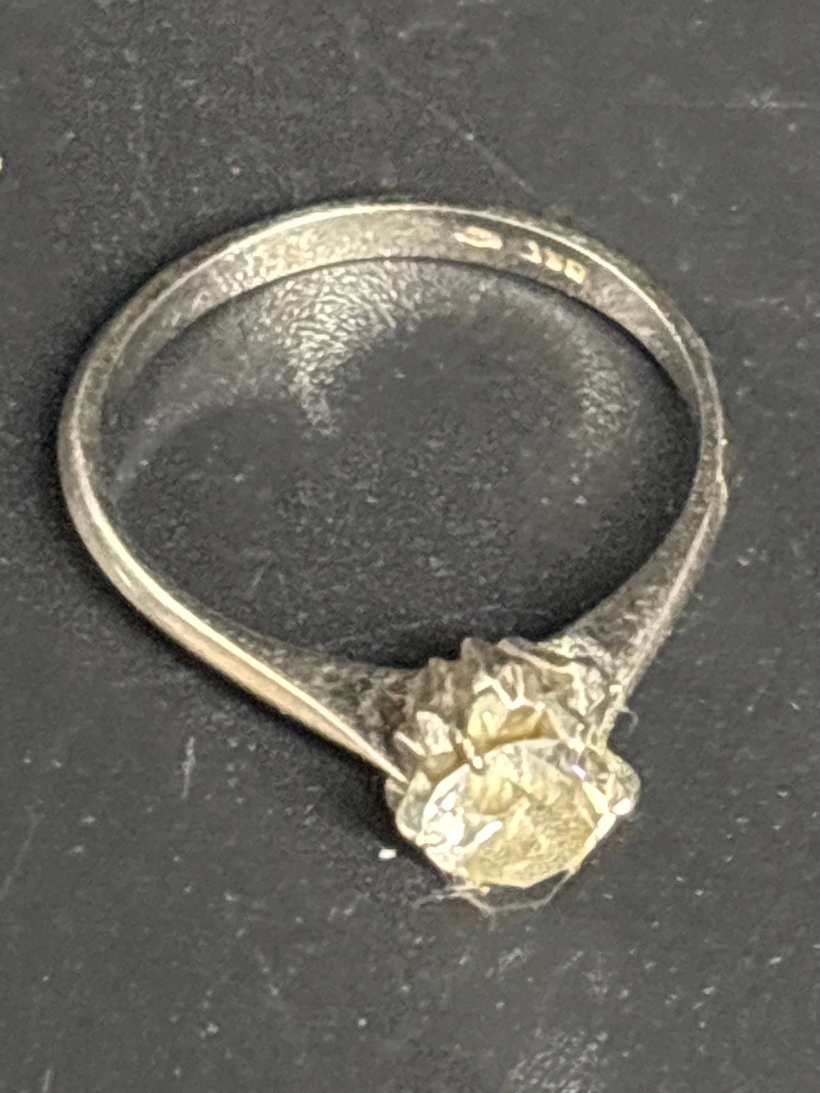 2.63 grams 18 k white gold vintage ring with diamond: solitaire ring featuring a central stone cradled in a multi-prong crown setting. It is made of 18k white gold.Identifying the GemstoneBased on its opaque, slightly yellow-tinted, crystalline structure