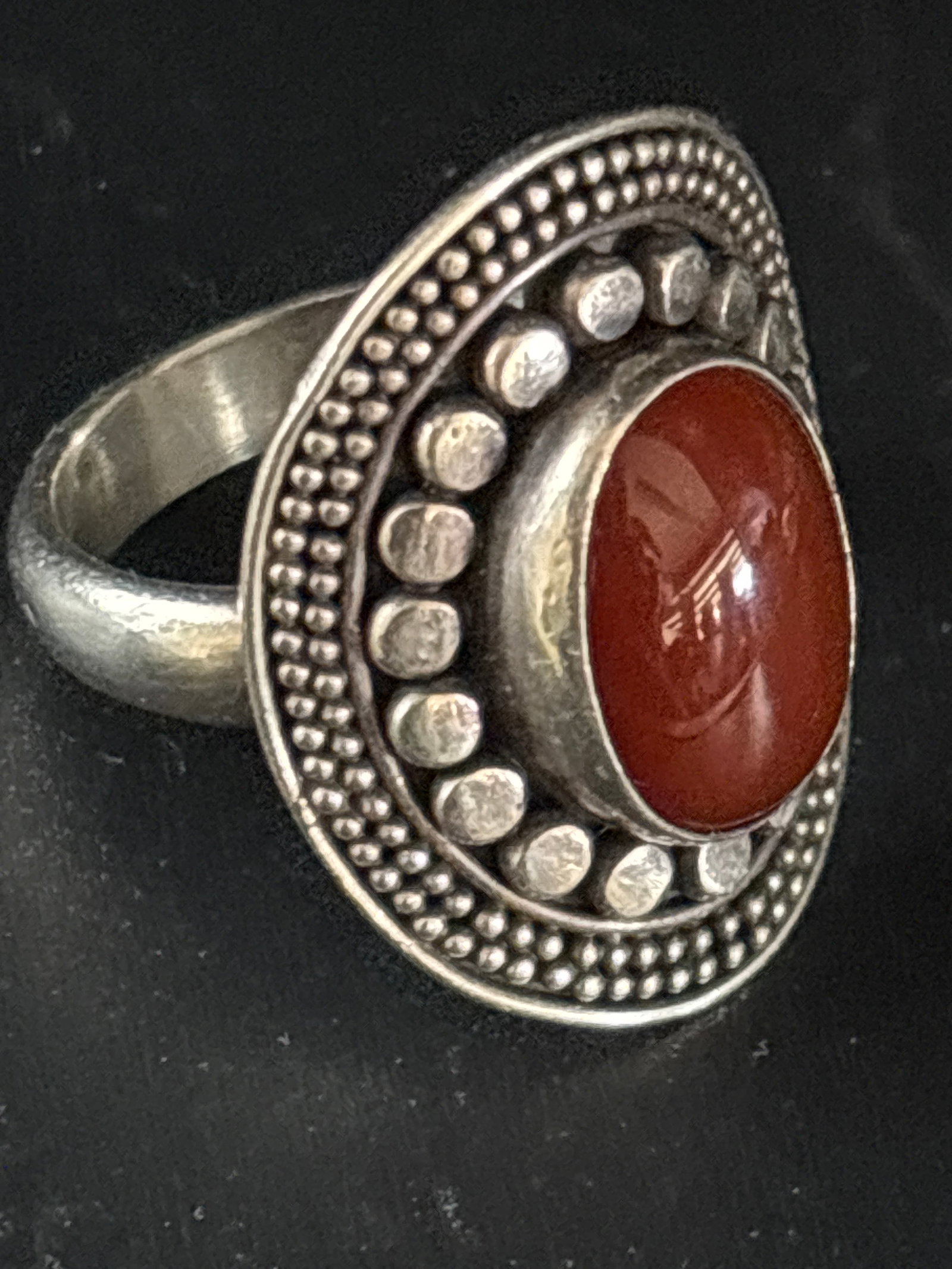 sterling silver bohemian ring features a bezel-set, oval-shaped red carnelian stone: sterling silver bohemian ring features a bezel-set, oval-shaped red carnelian stone surrounded by decorative granulated beads.Material: Sterling silver.Gemstone: Red carnelian, also known as red