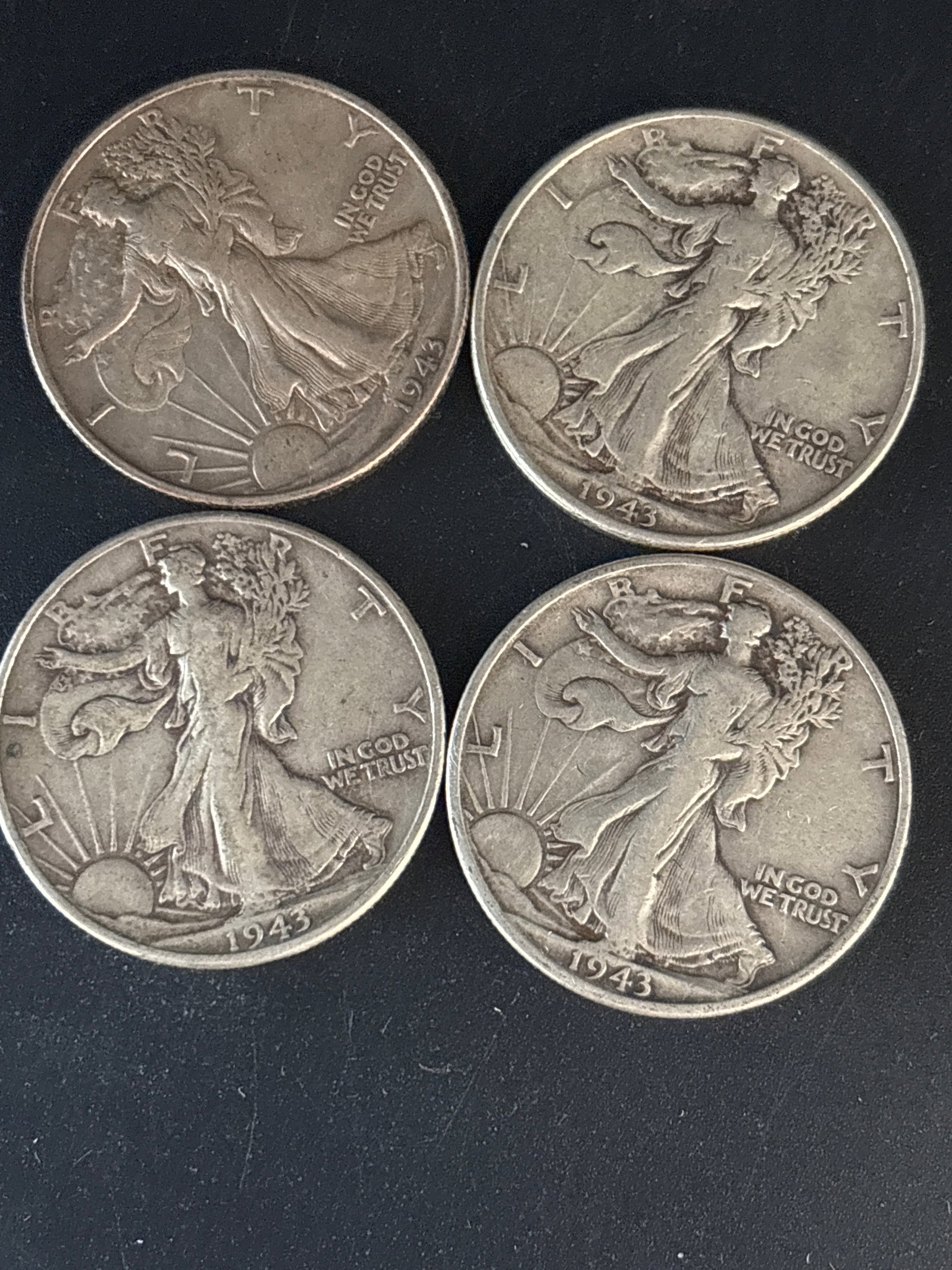 Four 1943 Walking Liberty Half Dollar coins: Four 1943 Walking Liberty Half Dollar coins. It is composed of 90% silver, with a total weight of 12.5 grams each .Value varies widely based on grade and mint mark (Philadelphia, Denver, or San Franci