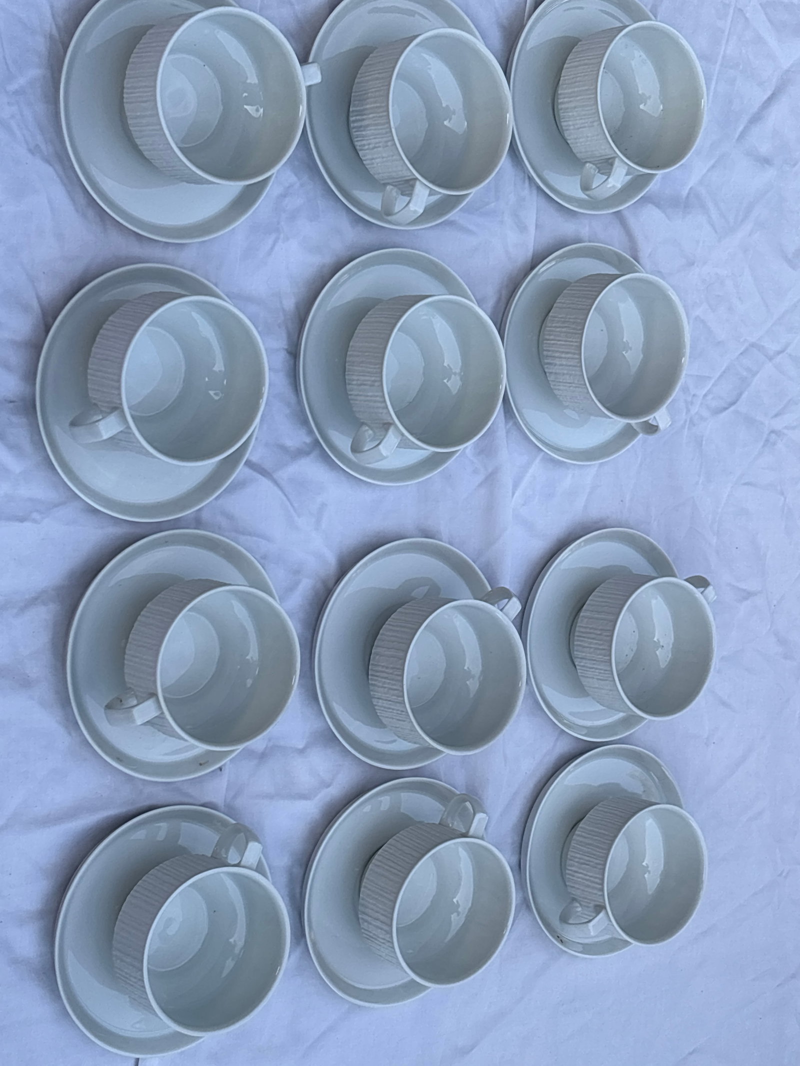 Set of twelve cups with saucers "Arcta White" line by Thomas Germany: Set of twelve cups with saucers "Arcta White" line by Thomas Germany, a division of Rosenthal, featuring a distinctive bark-like textured pattern.Brand: Thomas Germany (Rosenthal Studio-Line)Pattern: 