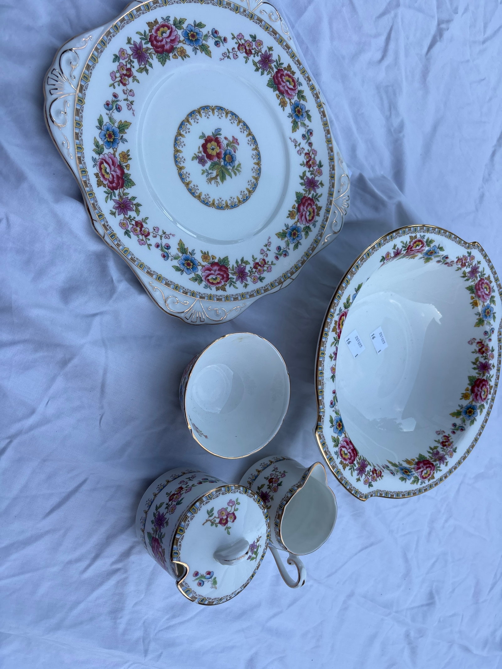 Five vintage Royal Grafton Malvern bone china pieces: Five vintage Royal Grafton Malvern bone china , identified by its colorful floral pattern and delicate gilt trim.Crafted in England, this pattern features vibrant multi-colored flowers against a white