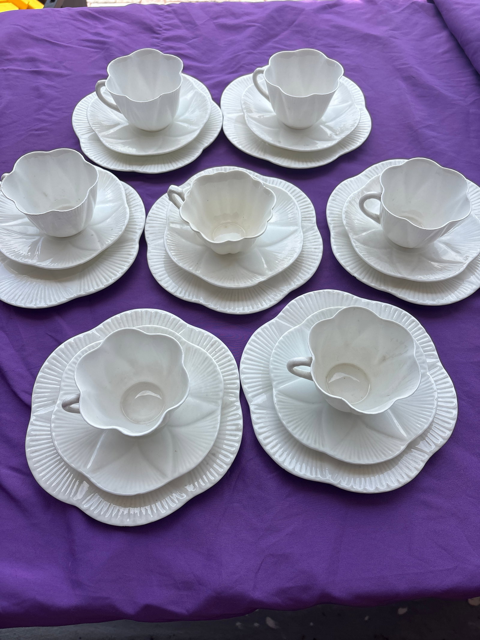 21 piece Shelley Art Deco dainty white set: Shelley Art Deco tea trio featuring a fine bone china cup and saucers in the "Dainty White" shape with a scalloped, flower-like design.Brand: ShelleyPattern: Dainty White (plain white)Design Details: 