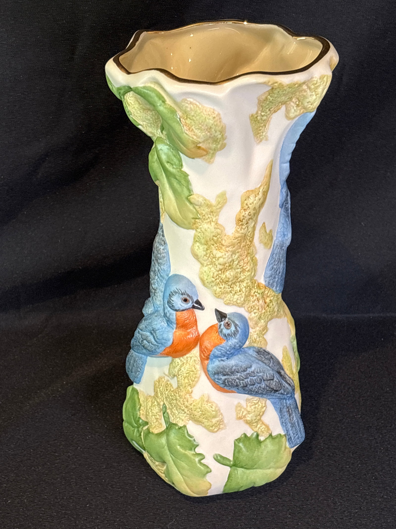 Cybis "Bluebird of Happiness" porcelain 10 inch vase: Cybis "Bluebird of Happiness" porcelain vase features hand-painted bluebirds perched on a white, textured branch design.Manufacturer: Cybis Porcelain Studio.Production Era: Introduced for retail in