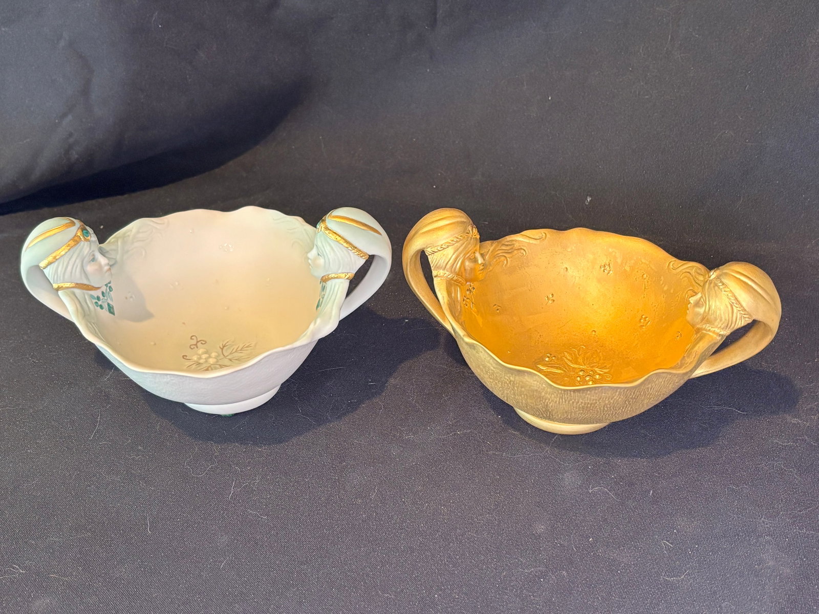 Two Vintage Cybis Porcelain Twin ‘Twins Gemini’ Handles 8 inch Bowl: Two Vintage Cybis Porcelain Twin Handles Bowl, produced in 1983. It is an elegant, scalloped fine china dish featuring sculpted handles with soft blue-green accents, gold-painted banding, and a