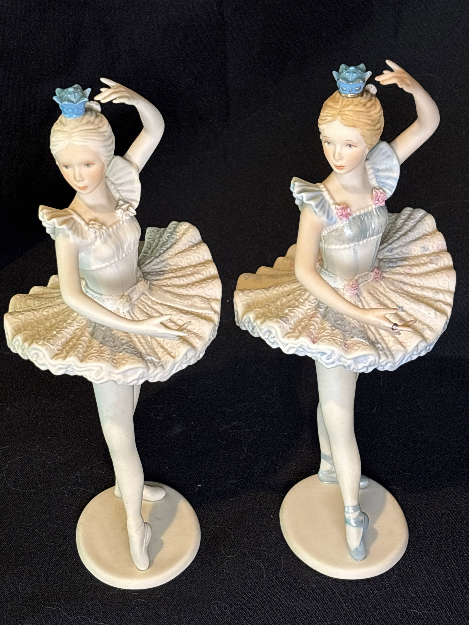 Two similar vintage Cybis bisque porcelain "Cynthia" ballerina 9&3/4 inch figurines: vintage Cybis bisque porcelain "Cynthia" ballerina figurine featuring a delicate pastel blue and ivory tutu with pink flower accents other is not colored.