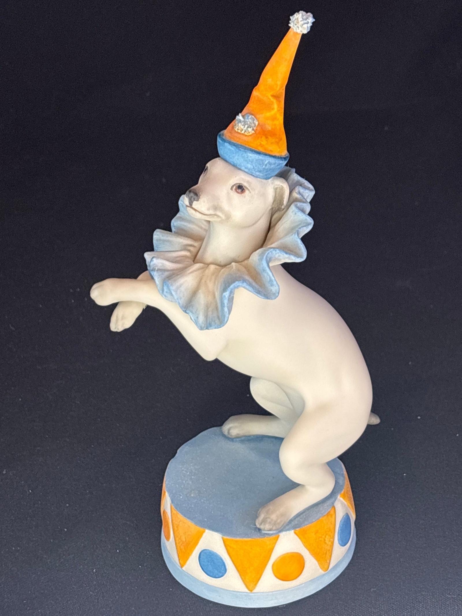 vintage Cybis porcelain 8 inch figurine titled "Dandy the Dancing Dog': vintage Cybis porcelain figurine titled "Dandy the Dancing Dog".Product DetailsManufacturer: Cybis Fine PorcelainCollection: Cybis Circus CollectionDesign Features: A white dog (resembling a Smooth Fo