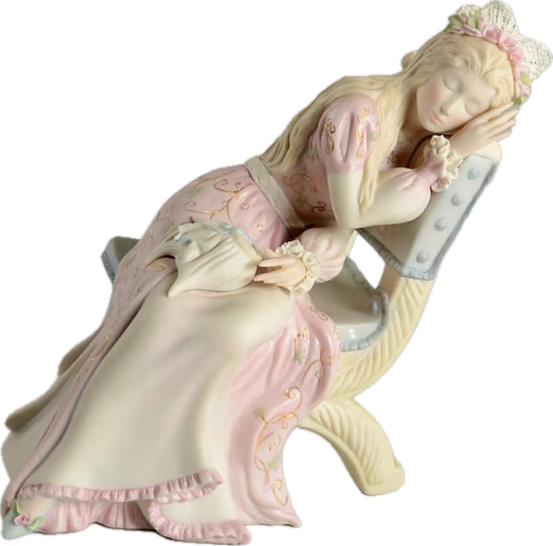 Limited edition Cybis Bisque Porcelain 'Sleeping Beauty' 7.75 inch Figurine: Cybis "Sleeping Beauty" is a retired, limited-edition porcelain figurine introduced by the Cybis Porcelain Studio in 1982. Standing about 7 3/4 inches tall, it depicts Princess Aurora resting on a cha