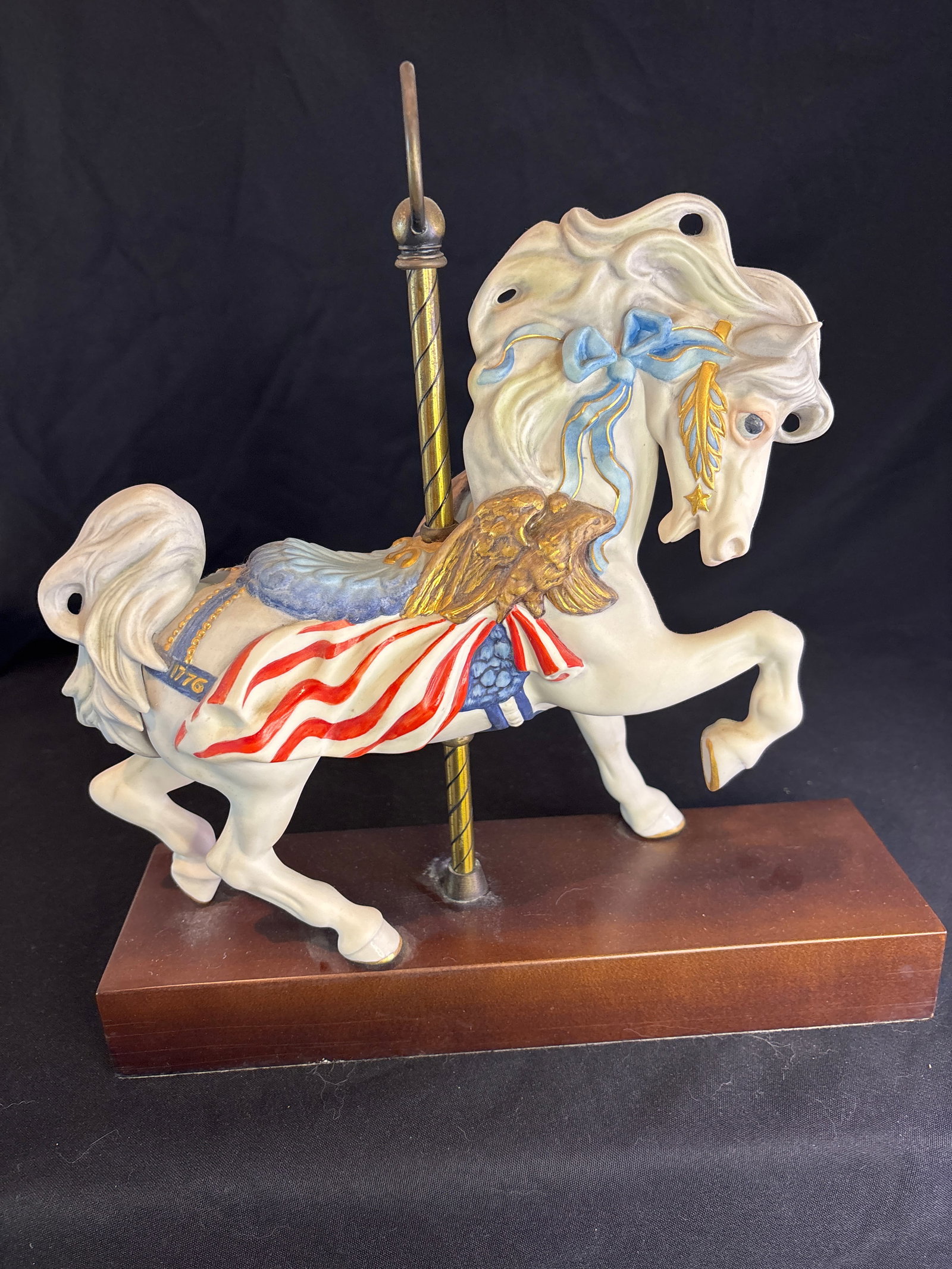 Limited edition Cybis Fine Porcelain "Ticonderoga" Bicentennial Carousel Horse: "Ticonderoga" Bicentennial Carousel Horse, a highly collectible, fine bisque porcelain sculpture created by the renowned Cybis Porcelain Studio.Key Details & BackgroundHistorical Significance: This pa