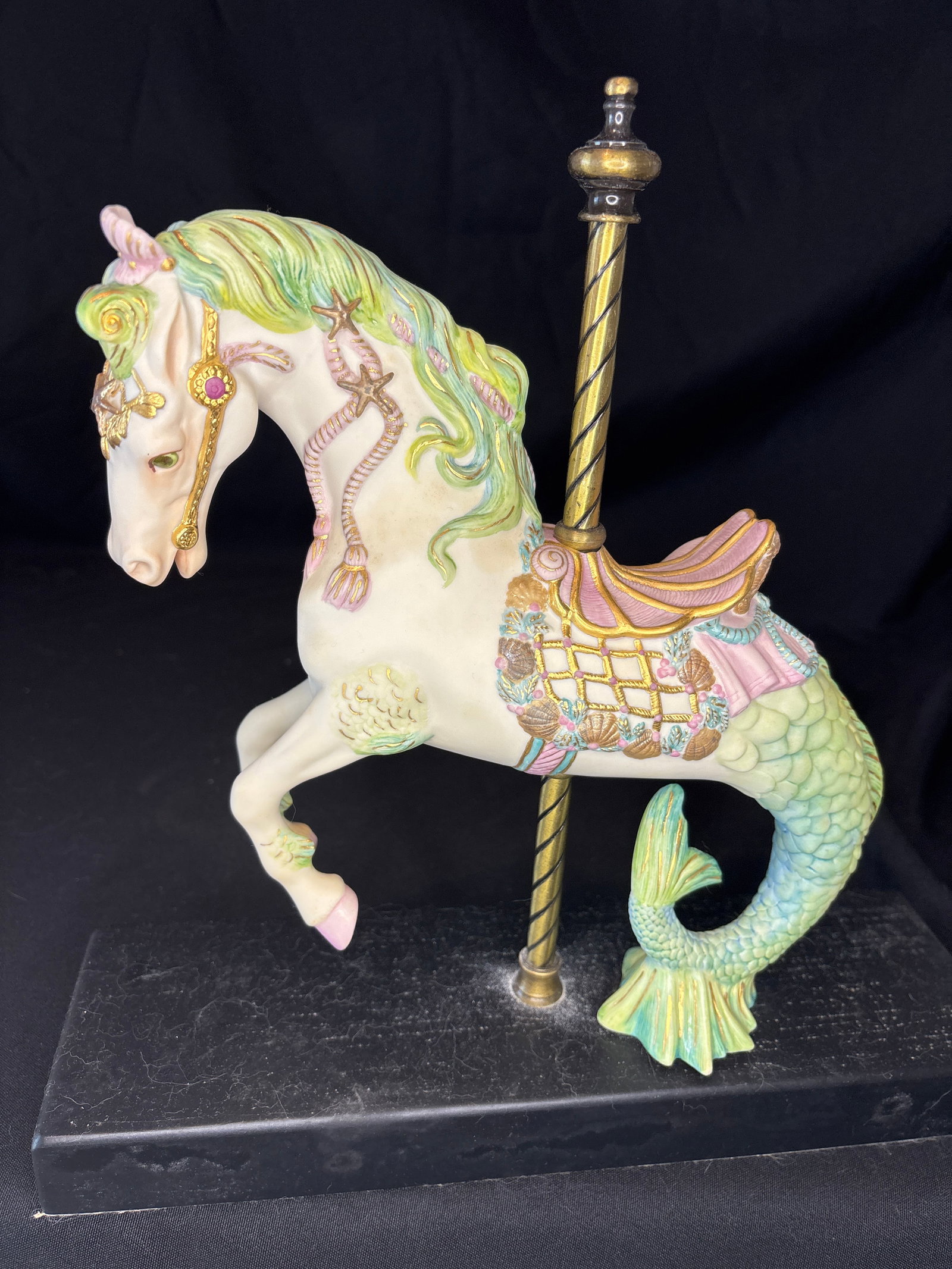 Limited production Cybis Carousel Seahorse Porcelain Figurine: Cybis Porcelain Carousel Seahorse Figurine. This whimsical, hand-painted sculpture depicts a mythical hippocampus (a half-horse, half-fish creature) designed with a green mane, a pink and gold