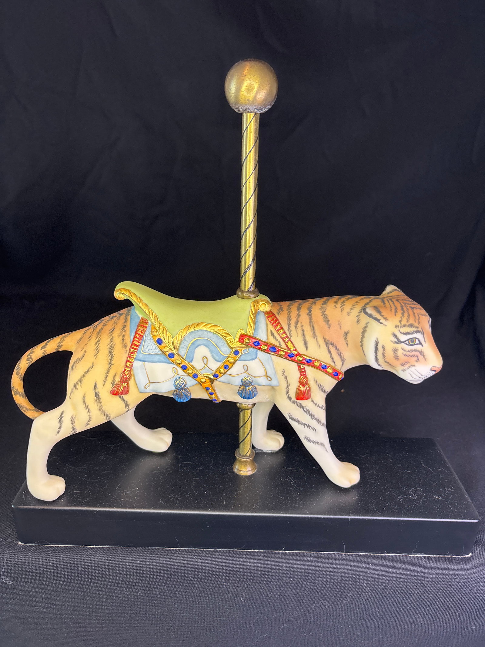 Limited edition Cybis Carousel Tiger Porcelain Figurine: porcelain Cybis Carousel Tiger figurine. Figurine DetailsBrand/Studio: It was created by Cybis Porcelain, an American porcelain studio known for high-quality collectible sculptures. Release History: T