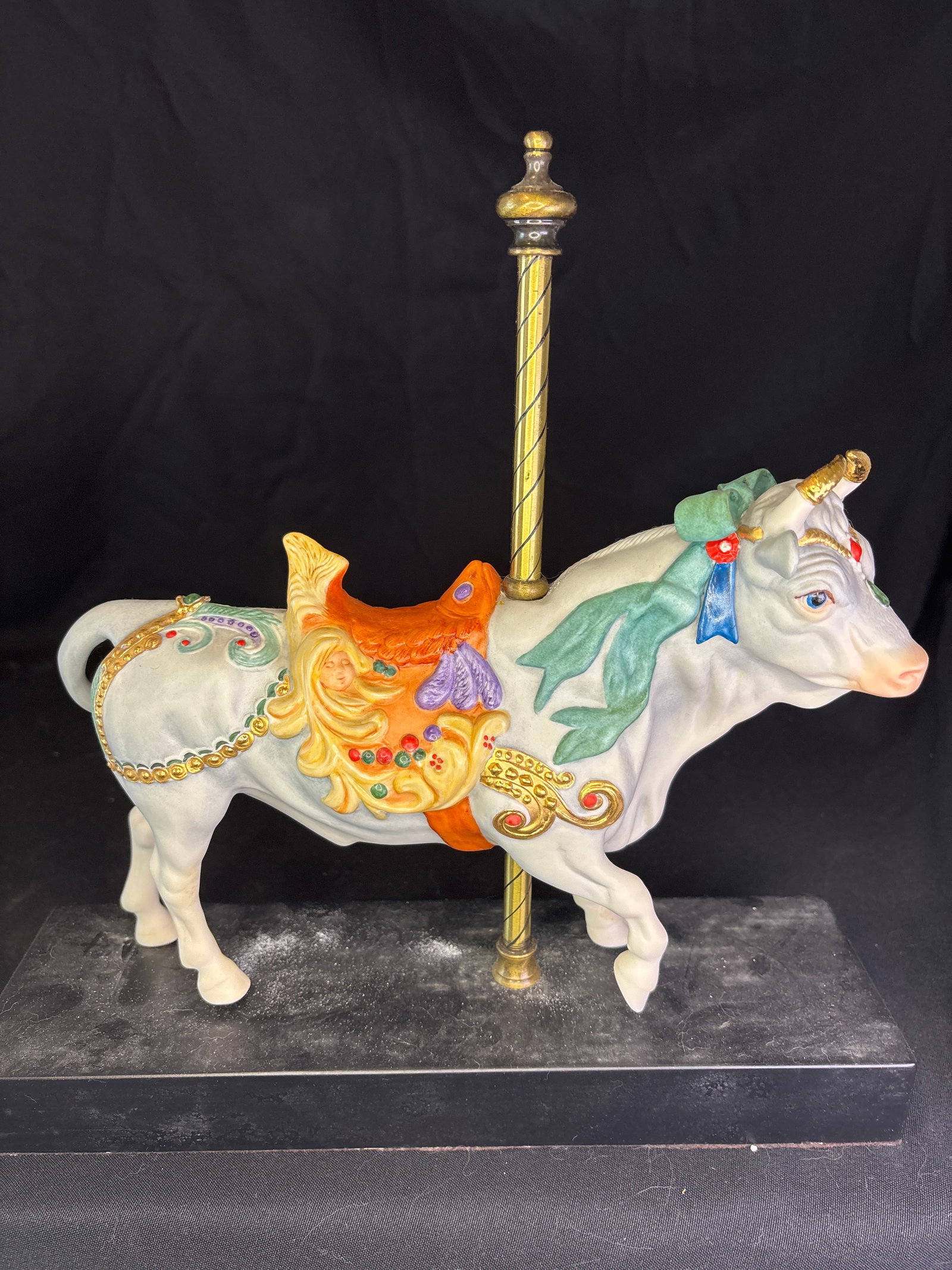 Limited edition 'Plutus' Cybis Carousel Bull Porcelain Figurine: Cybis Bisque Porcelain Carousel Bull Figurine named "Plutus". Designed by artist Susan Eaton, this collectible sculpture was originally issued in 1981. It depicts a white carousel bull with an orange