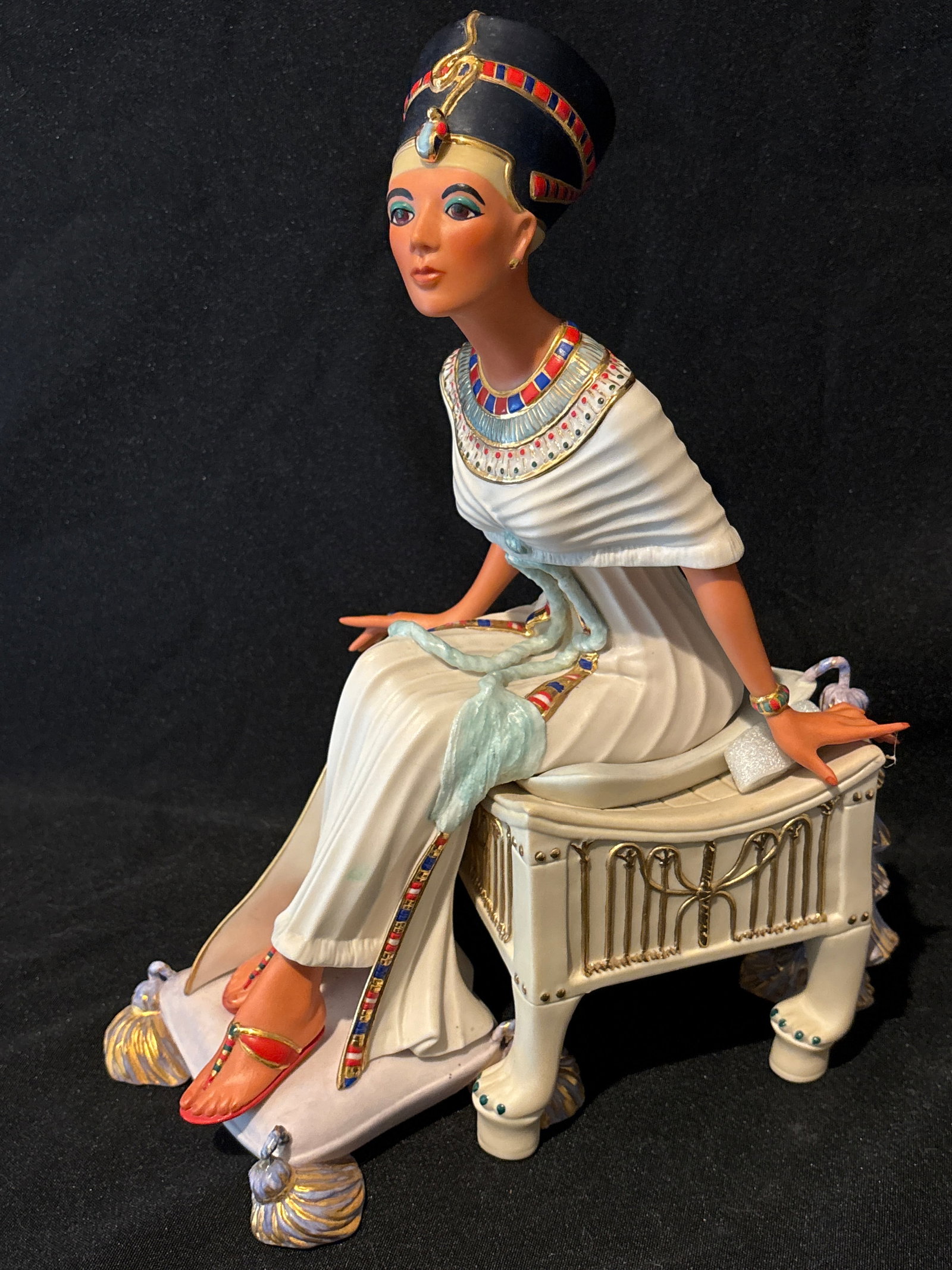 Strict limited edition Cybis seated "Queen Nefertiti" 12 inch sculpture: Introduced in 1979, this full-figure sculpture portrays the queen seated in splendor wearing her iconic crown and royal necklace. 1979 Cybis Seated Queen Nefertiti is a masterpiece of porcelain art, h
