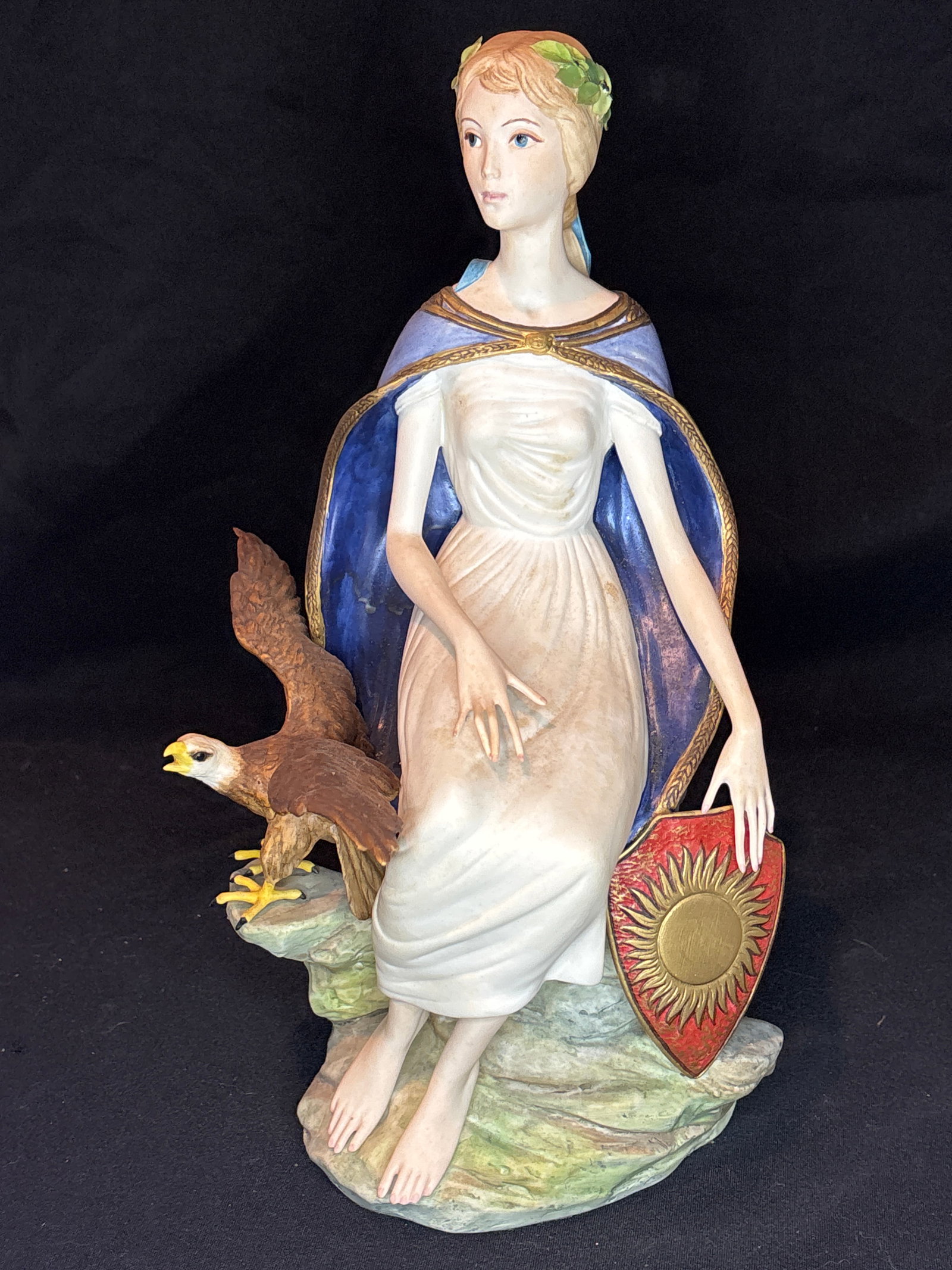 Columbia," a highly sought-after, limited-edition porcelain 14 inch statue: Columbia," a highly sought-after, limited-edition porcelain sculpture created by Cybis Porcelain.About the PieceIntroduction & History: Released in 1967 as a patriotic tribute, it completely sold out 