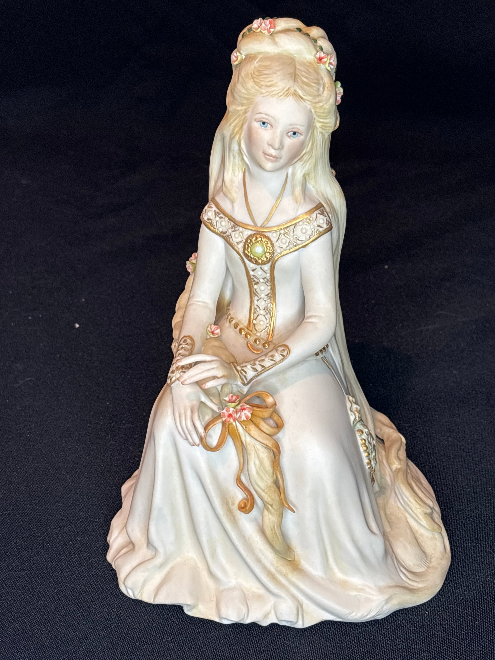 "Rapunzel" (Apricot Edition) Cybis porcelain 8.5 inch statue: "Rapunzel" (Apricot Edition) bisque porcelain figurine created by the Cybis porcelain studio.First introduced in Design: A seated young princess with flowing blonde hair and an ornate gown, measuring 