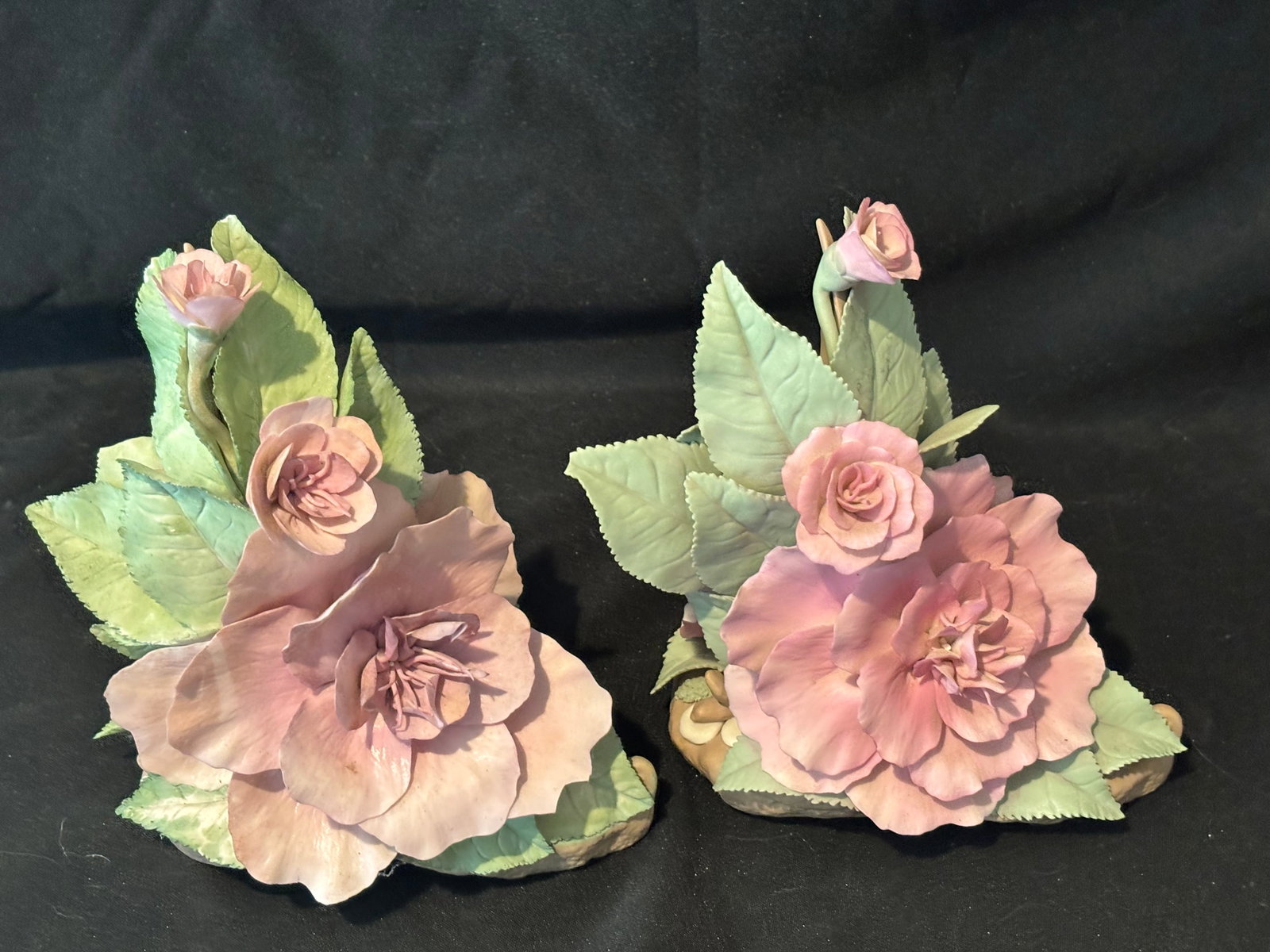 Two pink similar vintage Cybis porcelain rose sculptures: Two pink vintage Cybis porcelain rose sculptures. This specific model is a collectible bisque porcelain floral arrangement featuring a fully bloomed cream/yellow rose, an accompanying smaller rosebud 