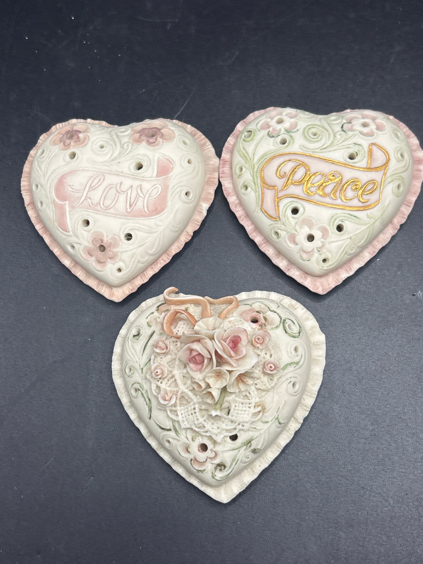 Three Cybis finely detailed lidded heart trinket boxes: Three finely detailed lidded heart trinket boxes produced by the American porcelain studio Cybis Porcelain.Collection DetailsBeginning in the mid-1970s, Cybis introduced these distinct, collectible bi