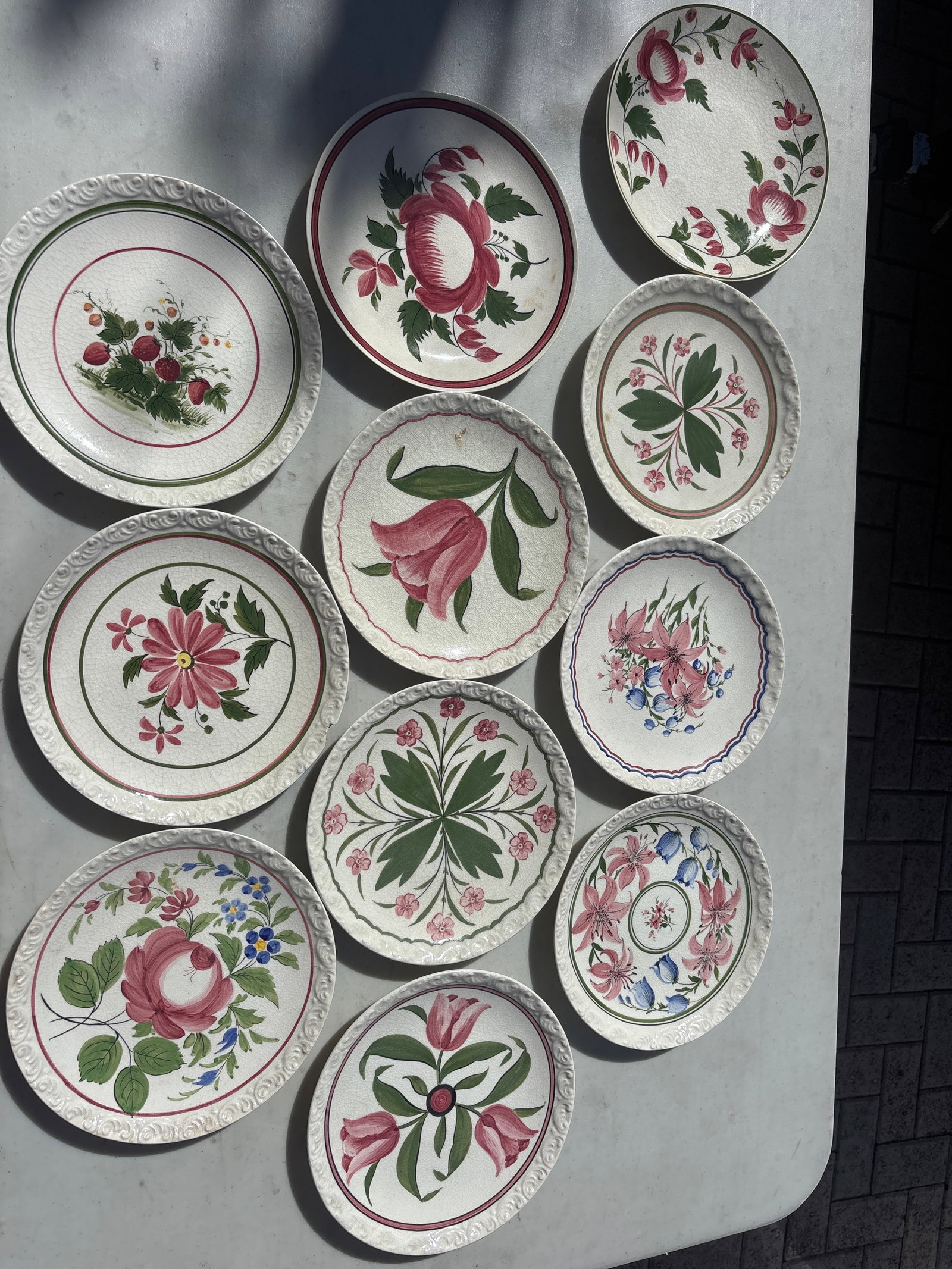 Eleven unsigned Cybis hand-painted ceramic plates: Eleven unsigned Cybis plates
