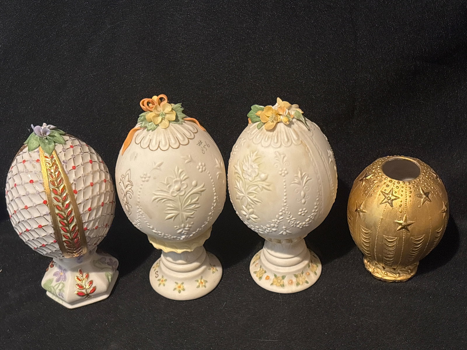 Chip to flower; Four eggs including Cybis porcelain 1985 Annual Decorative Eggs (1 of 8)