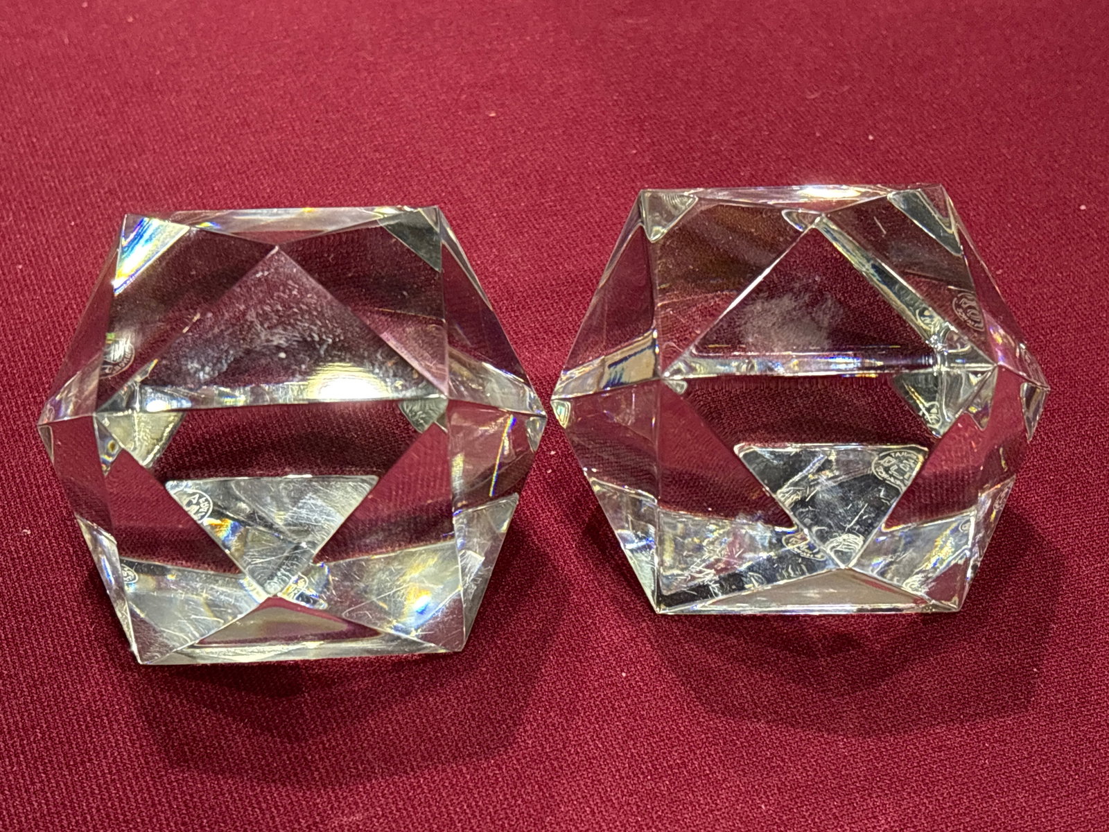 Pair of Baccarat crystal geometric prism 3&1/2 inch paperweights: Pair of Baccarat crystal prism paperweight, typically featuring 14 sides.It is crafted to refract light through its numerous facets, often designed for desk or decorative use.Similar items can be foun