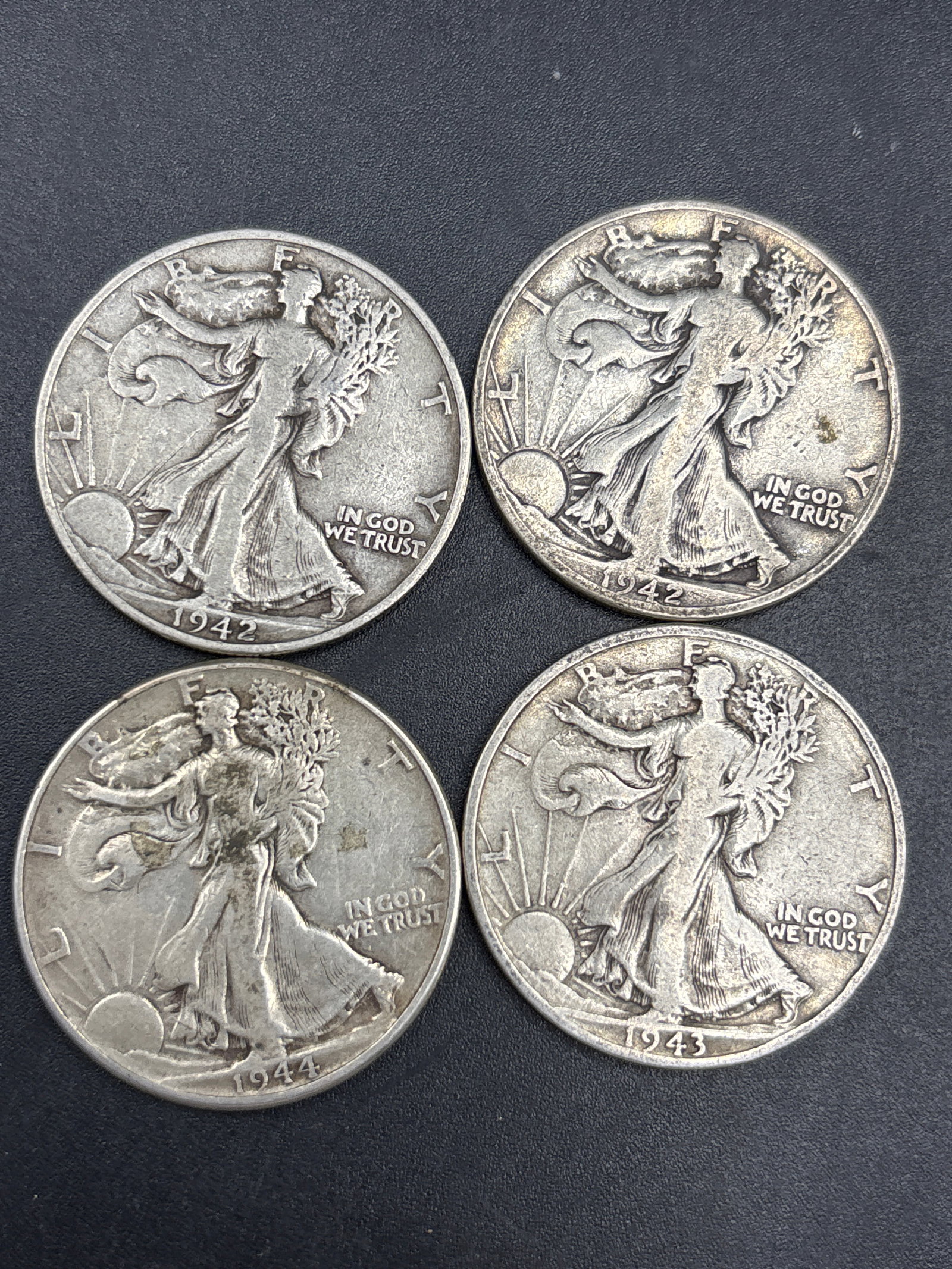 Group of four WWII era Silver U.S. Walking Liberty Half Dollars: Group of four early Silver U.S. Walking Liberty Half Dollars, minted between 1892 and 1915.It is composed of 90% silver.The value depends on the year, mint mark, and condition, with some circulated ex