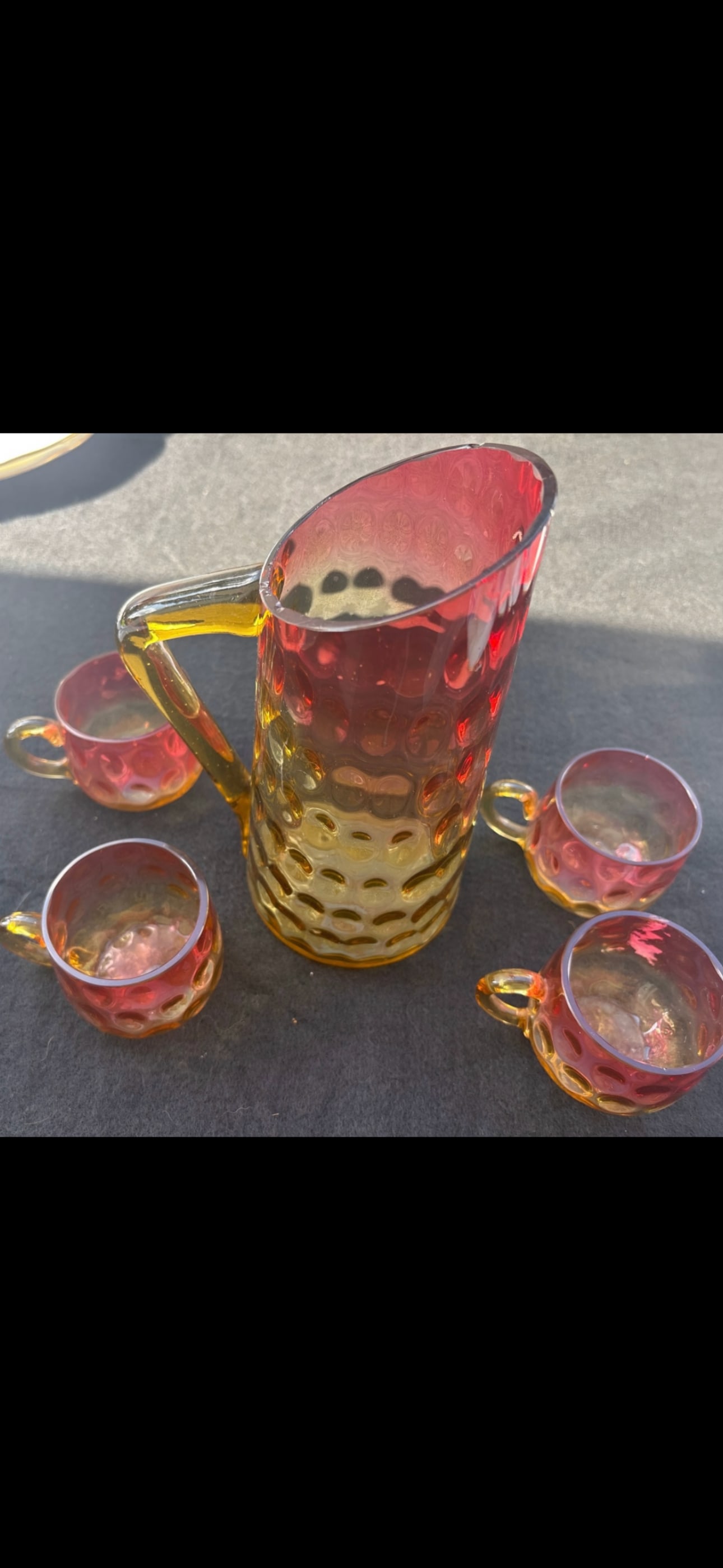 Amberina set 19th C. Boston & Sandwich Glass Company glasses: antique Amberina glass pitcher, featuring a distinct inverted thumbprint (or coin dot) pattern and an amber-colored applied glass handle.Amberina is a celebrated two-toned American art glass known for
