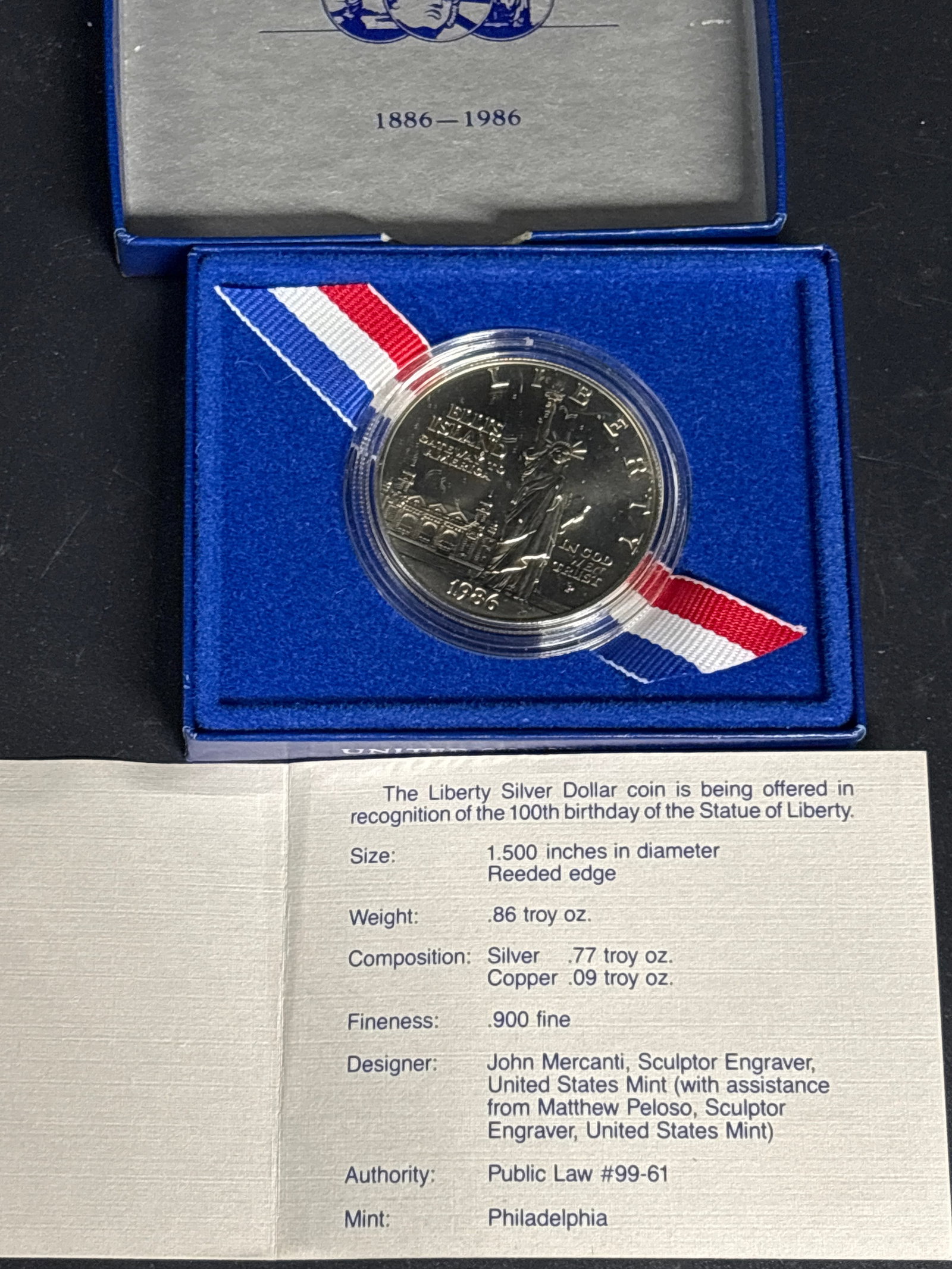.77 TO .90% Silver 1986 United States Statue of Liberty Centennial Silver Dollar: 1986 United States Statue of Liberty Centennial Silver Dollar, commemorating the 100th anniversary of the Statue of Liberty.The coin shown features a proof finish and is housed in a protective capsule