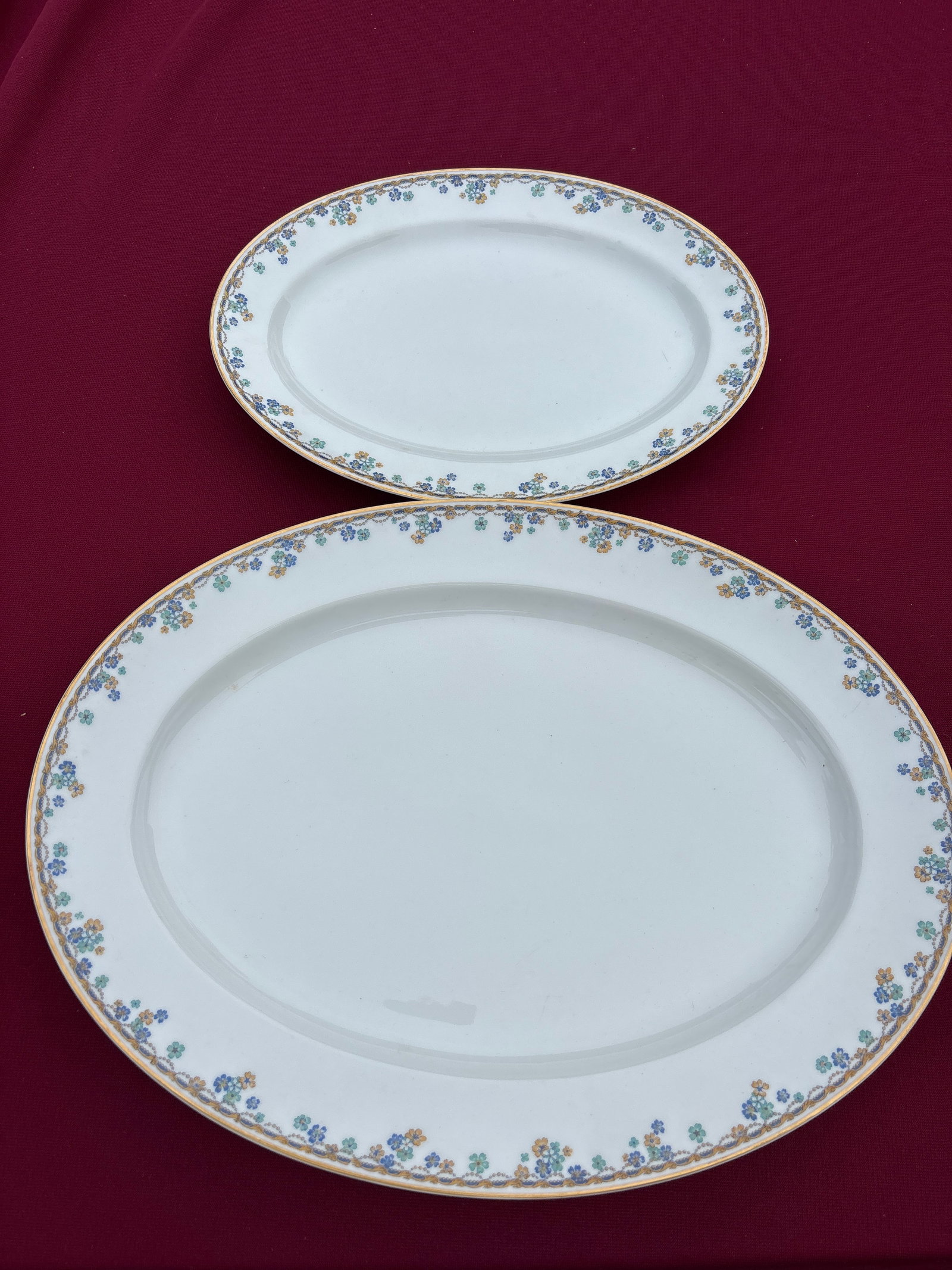 Two Haviland Limoges France Vincennes pattern serving platters: Four Haviland Limoges France Vincennes pattern serving platters featuring a delicate floral and scroll border with gold trim.The pattern, often listed as Schleiger 108, includes blue and yellow flower