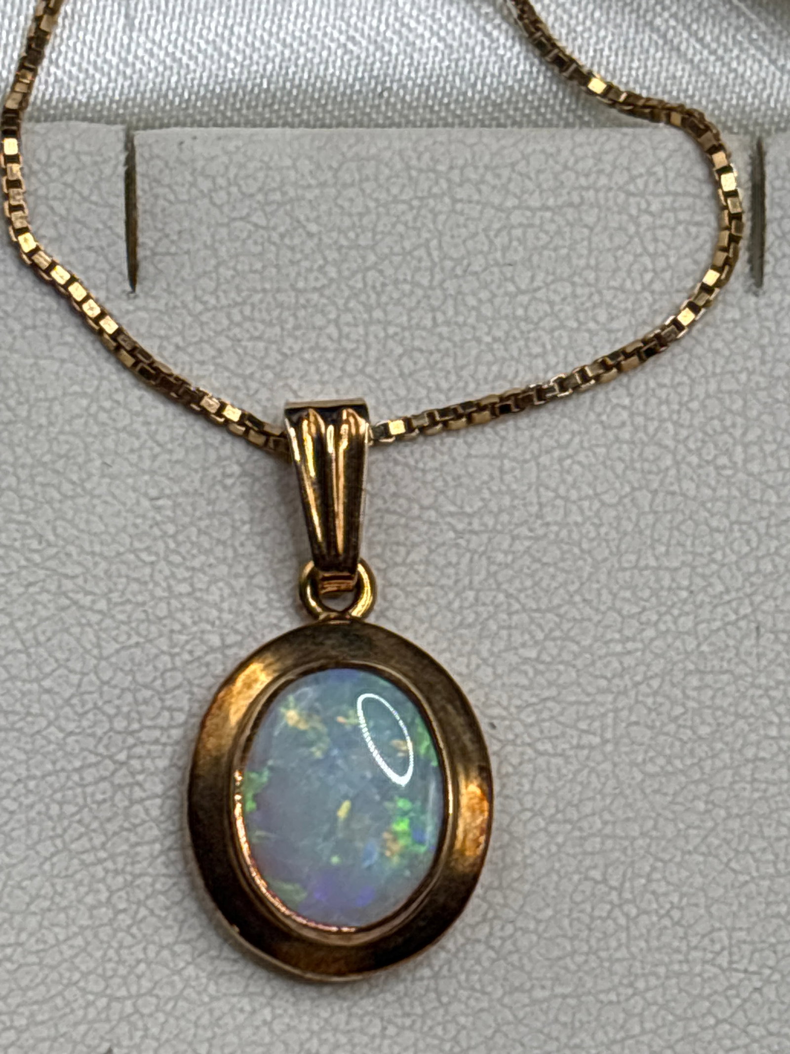 3.5 grams 9-karat yellow gold oval opal pendant necklace: 3.5 grams 9 k opal pendant on 9 k chain.9-karat yellow gold oval opal pendant necklace, presented in its original presentation box from Denhams the Jewellers.Key CharacteristicsGemstone: Natural oval-