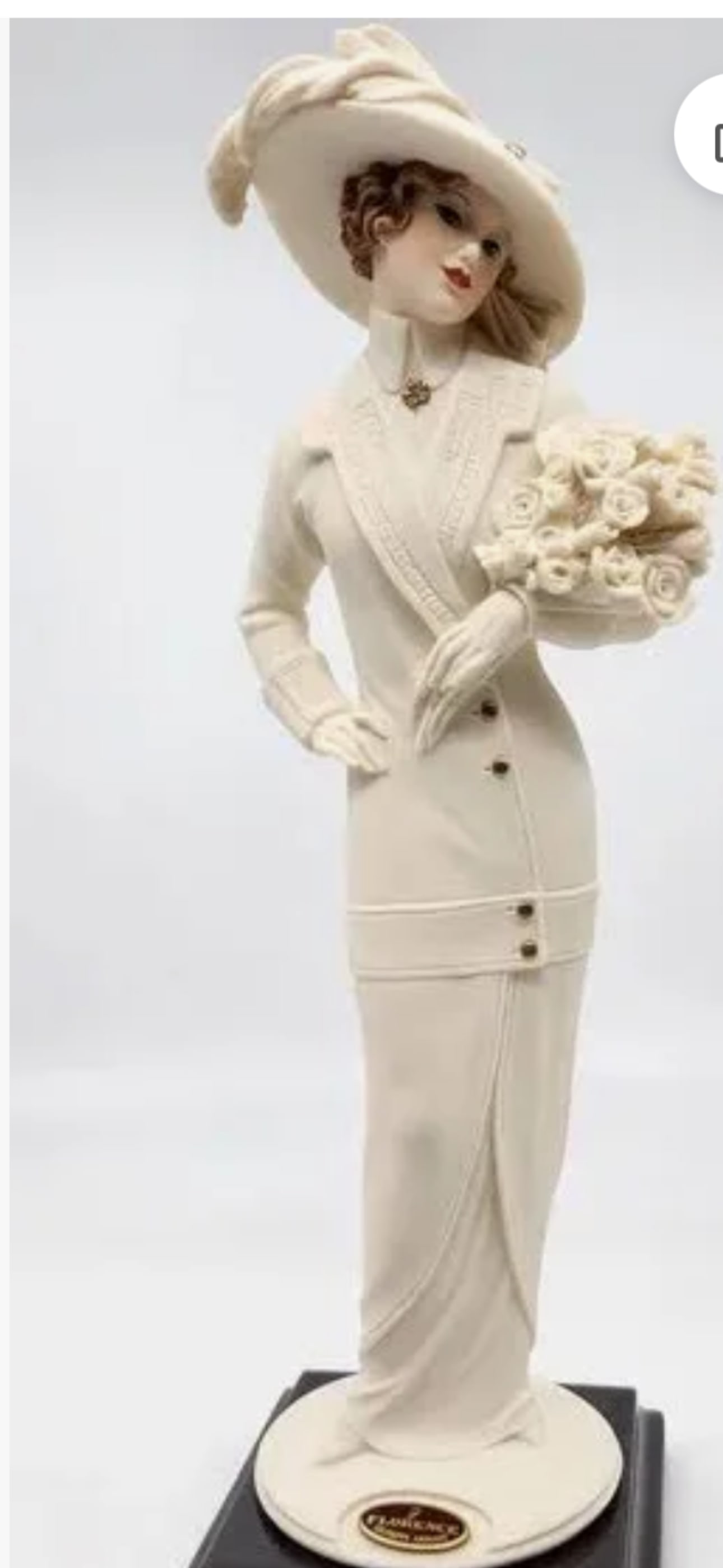 Giuseppe Armani "Raquel" porcelain figurine, specifically item number 1309F: No box.Giuseppe Armani "Raquel" porcelain figurine, specifically item number 1309F from the "My Fair Ladies" collection.The sculpture depicts a woman in a white suit and hat holding a bouquet of flowe
