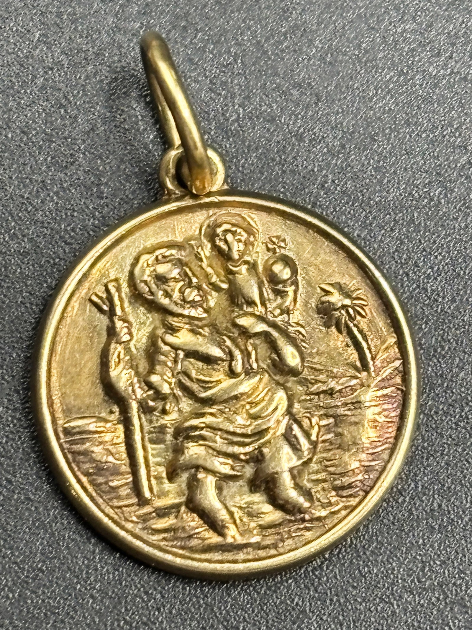 Smaller 3.92 grams English yellow gold St Christopher medallion; 1 inch: 9k yellow gold St. Christopher medallion pendant.St. Christopher is the traditional Christian patron saint of travelers. The center engraving depicts the classic iconography of the saint carrying the 