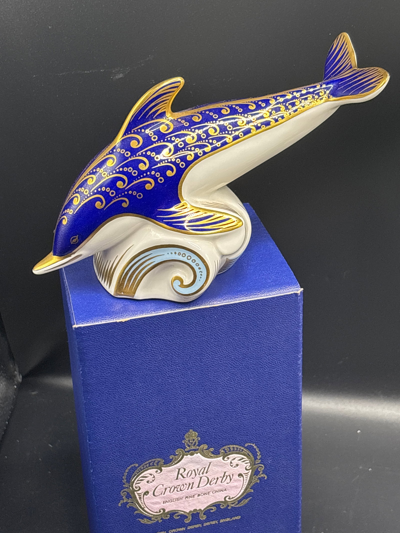 Large Bottlenose Dolphin Royal Crown Derby England 7 inch Paperweight: Gold stopper. With box. Royal Crown Derby Bottlenose Dolphin Paperweight. It features fine English bone china adorned with a striking cobalt blue Imari pattern and lavish 22-karat gold hand-painted de