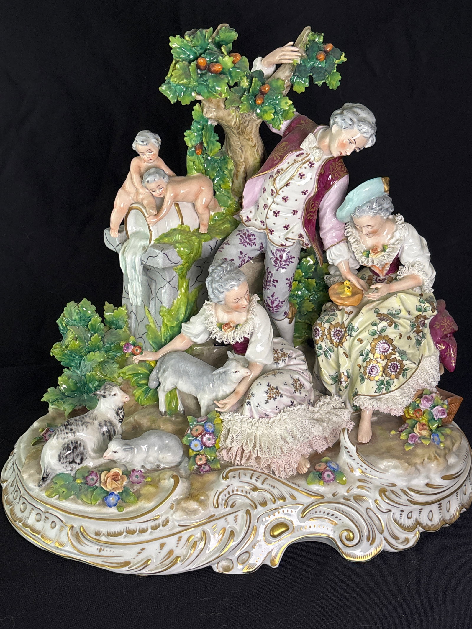 Large German Sitzendorf porcelain pastoral group figurine intricately hand-painted figures: Large German manufacturer Sitzendorf, located in the Thuringia region.Mark DetailsThe Symbol: It shows a distinctive crown over a stylized "S" script monogram.The Origin: The Sitzendorf Porcelain Manu