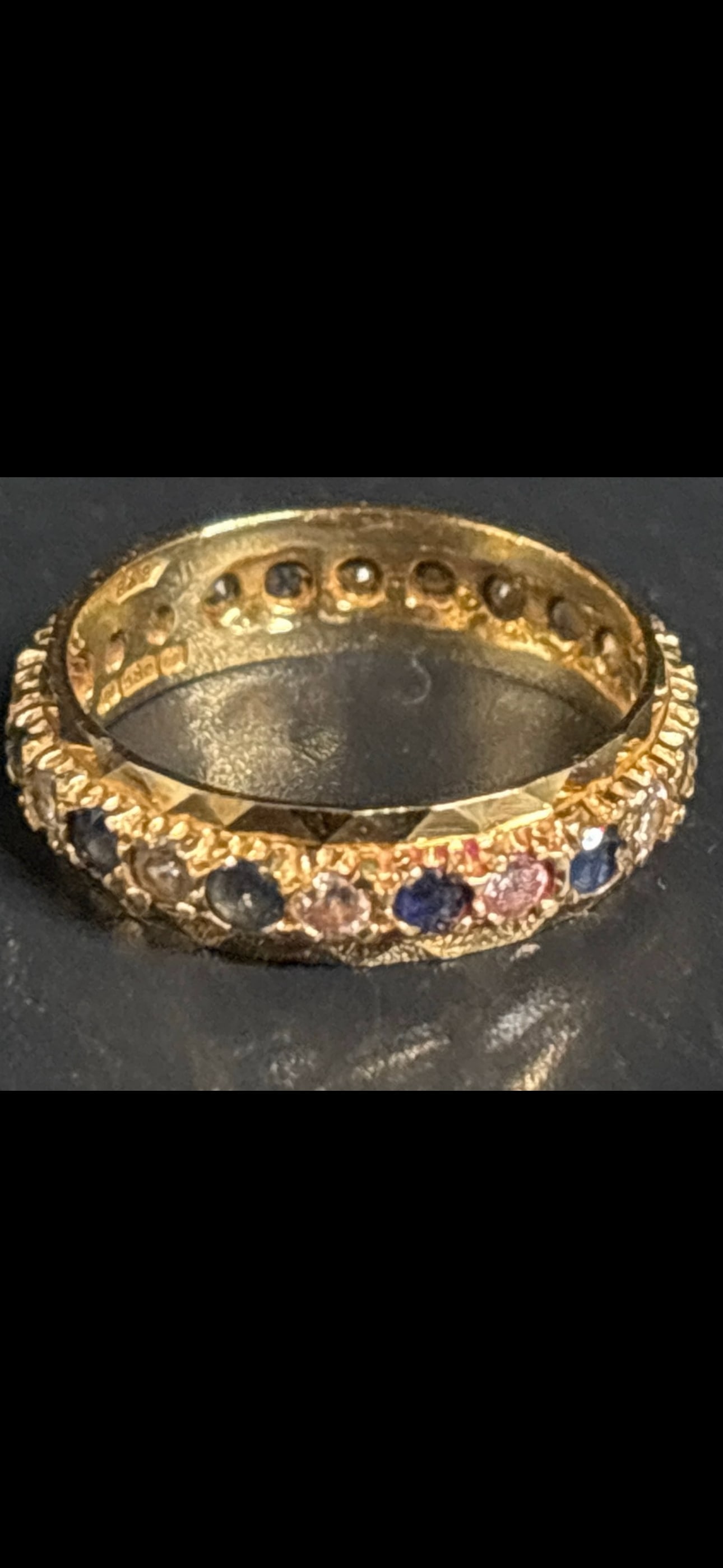 14 yellow k 3.4 grams vintage ring with inset jewels: 14k yellow gold full eternity band ring accented with a continuous row of pave-set stones. It features prominent open gallery holes on the inner setting of the band, designed to allow maximum light