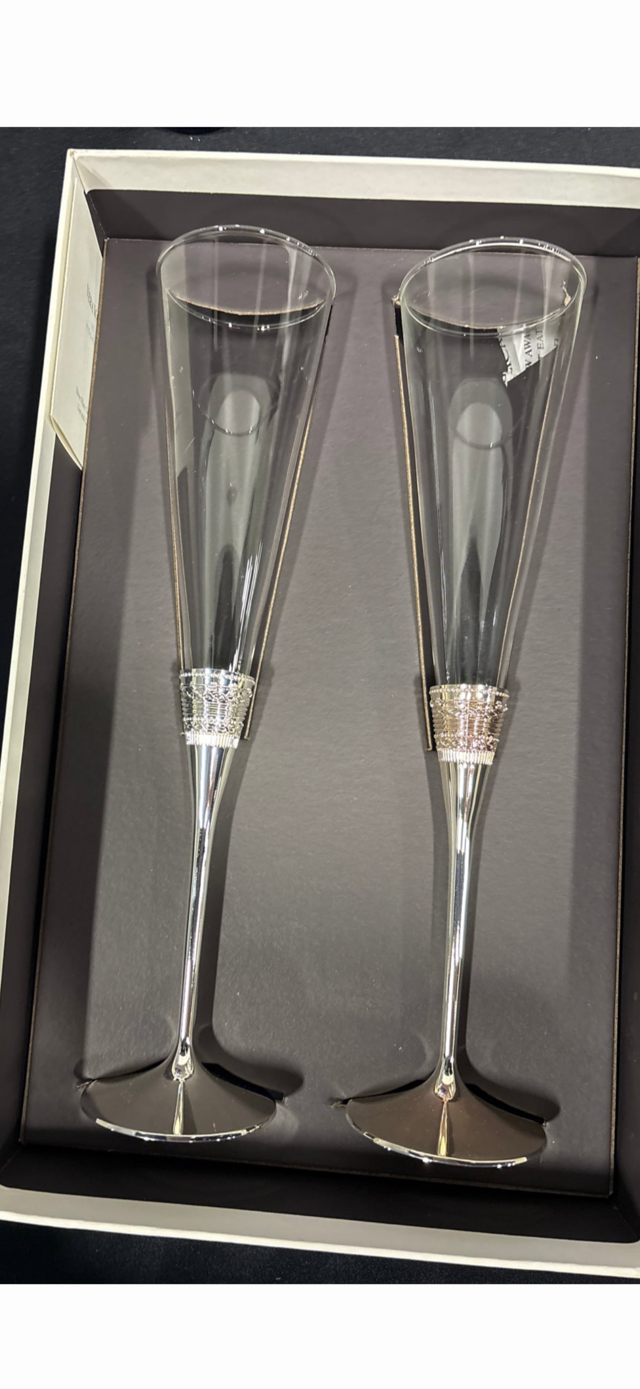 Vera Wang for Wedgwood toasting flutes from the "With Love" collection: Vera Wang for Wedgwood toasting flutes from the "With Love" collection.KeyFeaturesDesign: This set features a clear crystal bowl with a silver-plated stem and base.Signature Motif: The decorative