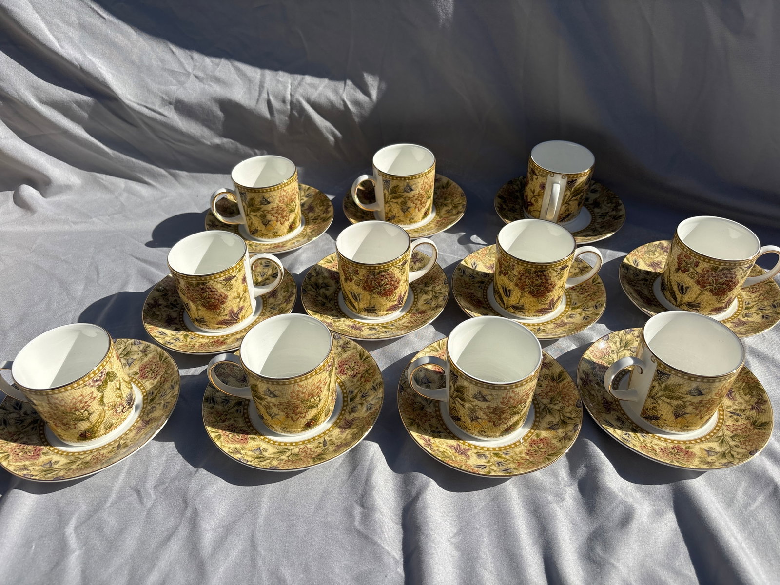 Set of eleven Wedgwood Floral Tapestry pattern fine bone china coffee cans with saucers: Set of twelve fine bone china coffee cans with saucers featuring the Wedgwood Floral Tapestry pattern.Pattern DetailsManufacturer: Produced by the renowned British company Wedgwood.Production Era: Thi