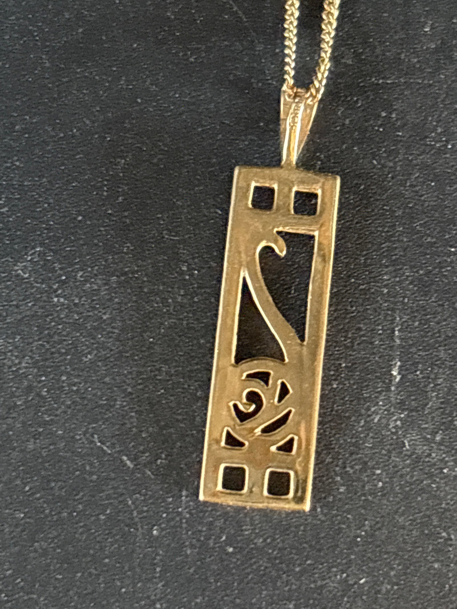 2.26 grams 9 k yellow gold Charles Rennie Mackintosh style pendant & chain: Charles Rennie Mackintosh style pendant featuring the iconic "Glasgow Rose" motif.Design BackgroundStyle: The linear framing combined with stylized curves is characteristic of the late Art Nouveau
