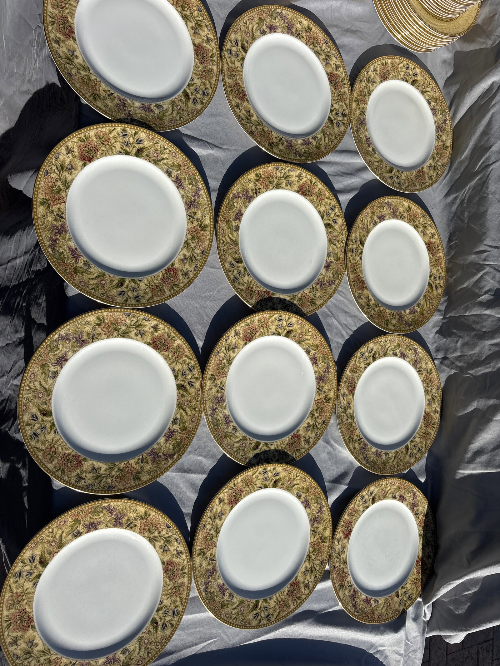Set of twelve Wedgwood Floral Tapestry 10 3/4-inch Dinner Plates: Set of twelve Wedgwood Floral Tapestry 10 3/4-inch Dinner Plates crafted from fine bone china in England.Pattern Details: Features a textured olive and sage green border with multicolored floral