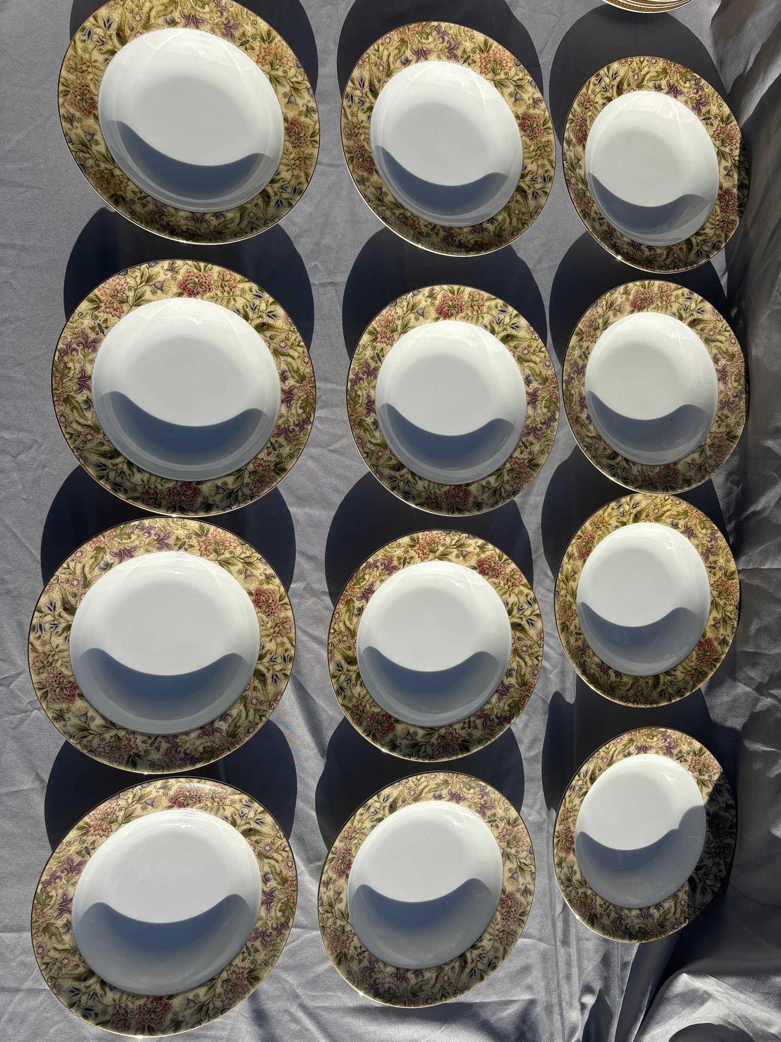 Set of twelve Wedgwood Floral Tapestry 8 inch rimmed bowls: Set of twelve Wedgwood Floral Tapestry 8 inch rimmed bowls crafted from fine bone china in England.Pattern Details: Features a textured olive and sage green border with multicolored floral sprays,